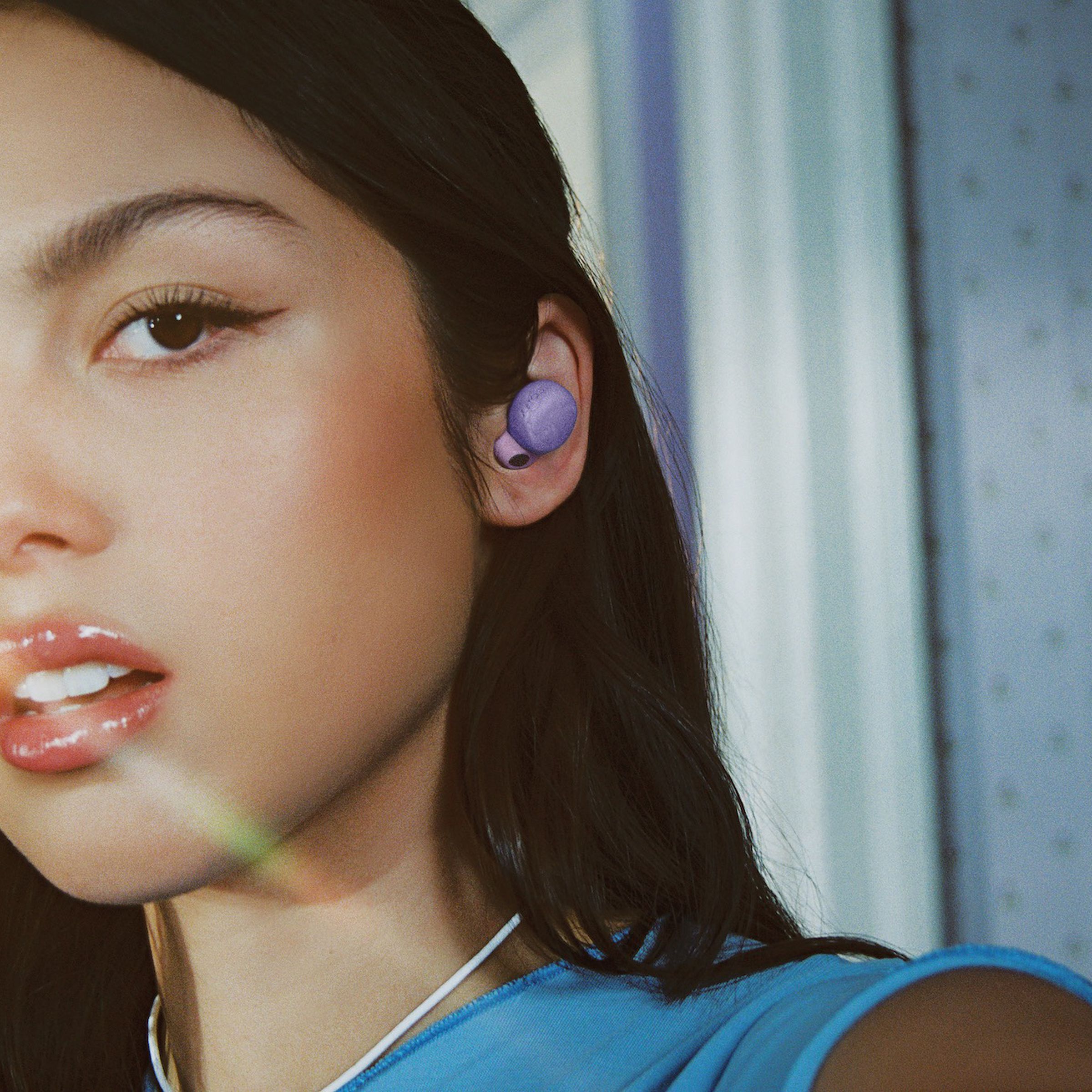 An image of Olivia Rodrigo wearing her signature Sony LinkBuds S earbuds.