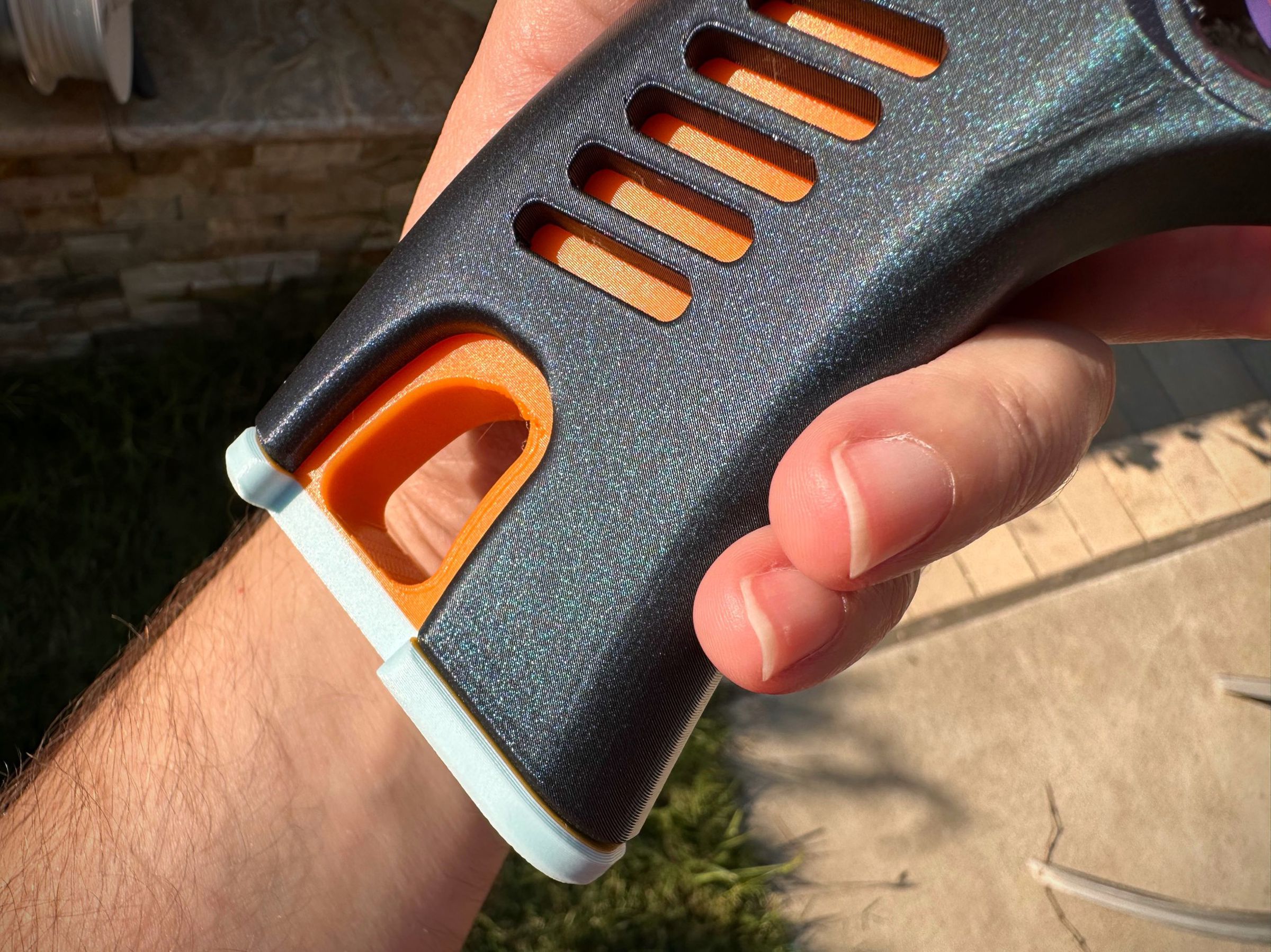 This grip insert is a two-color print, orange atop ice blue. High-res image here.