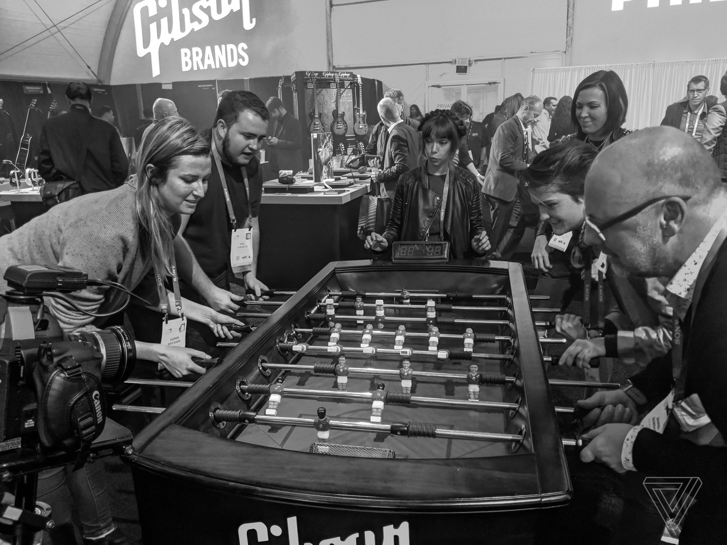 (left to right) Sophie Erickson, Phil Esposito, Sarah Bishop, Dani Deahl, Becca Farsace and James Bareham play table football in the Gibson tent