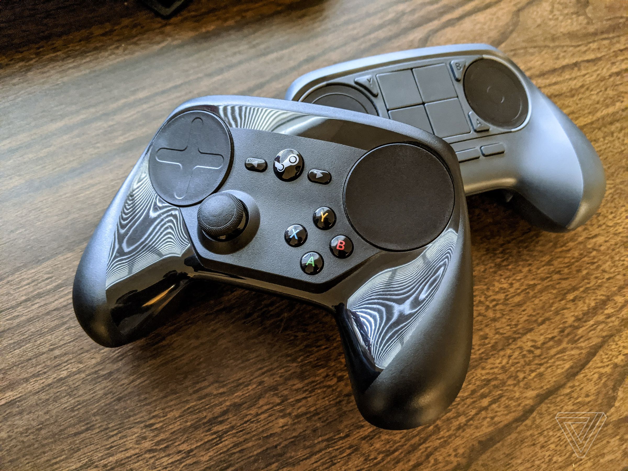 My Steam Controller, next to an earlier prototype.