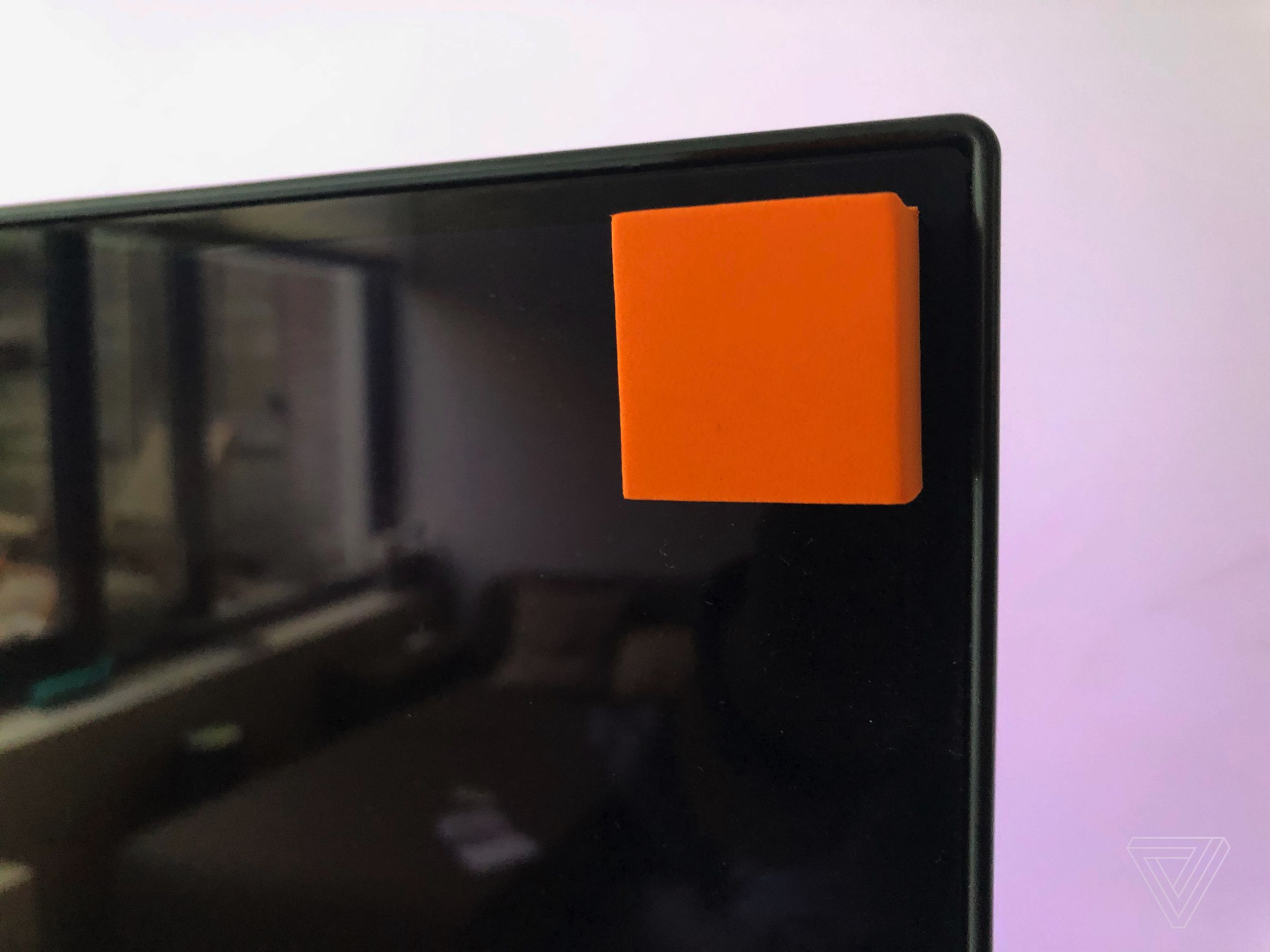 <em>The orange adhesive pads used for calibration came off without leaving residue on the display.</em>