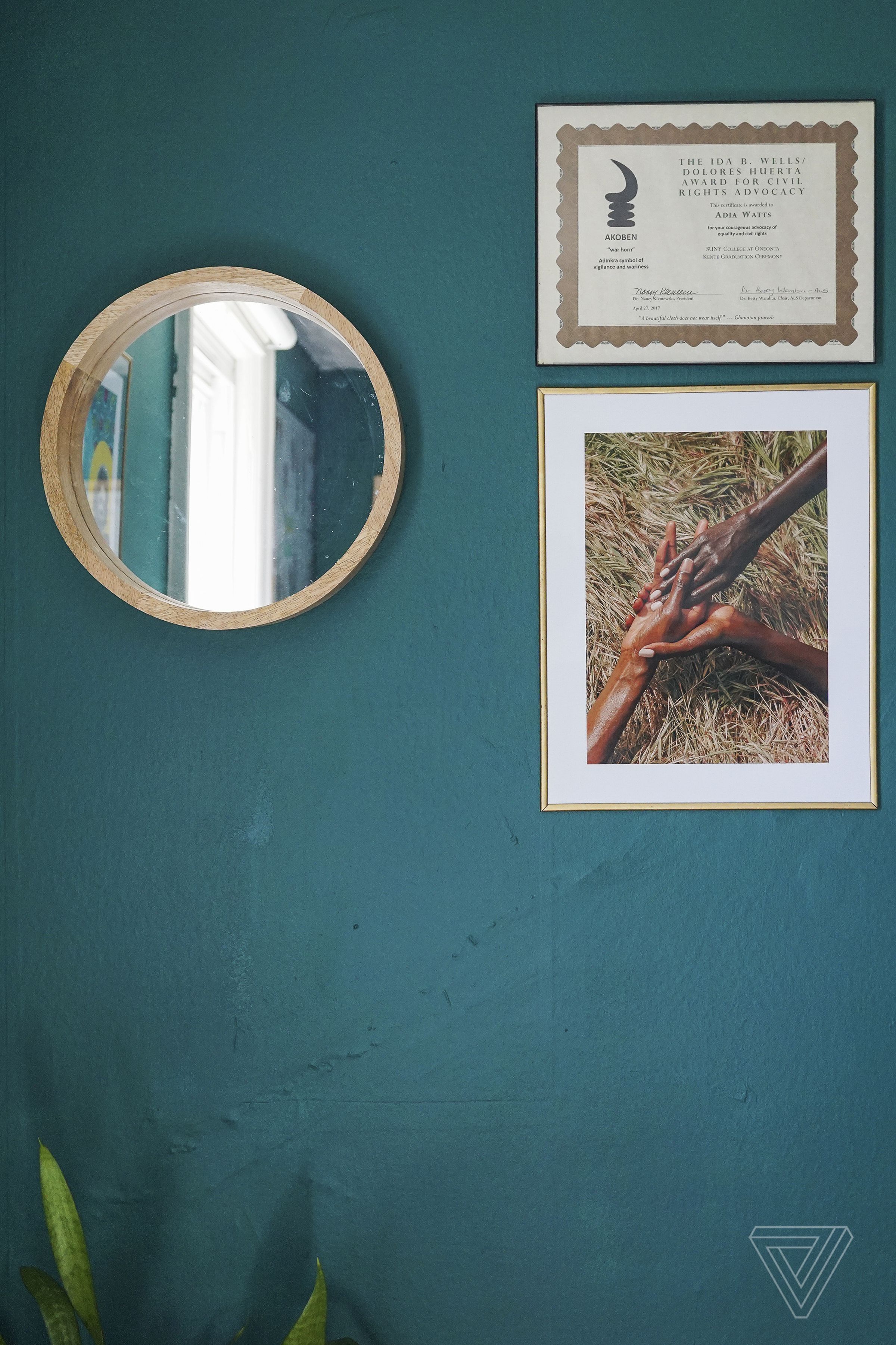 A mirror, an award, and a photograph