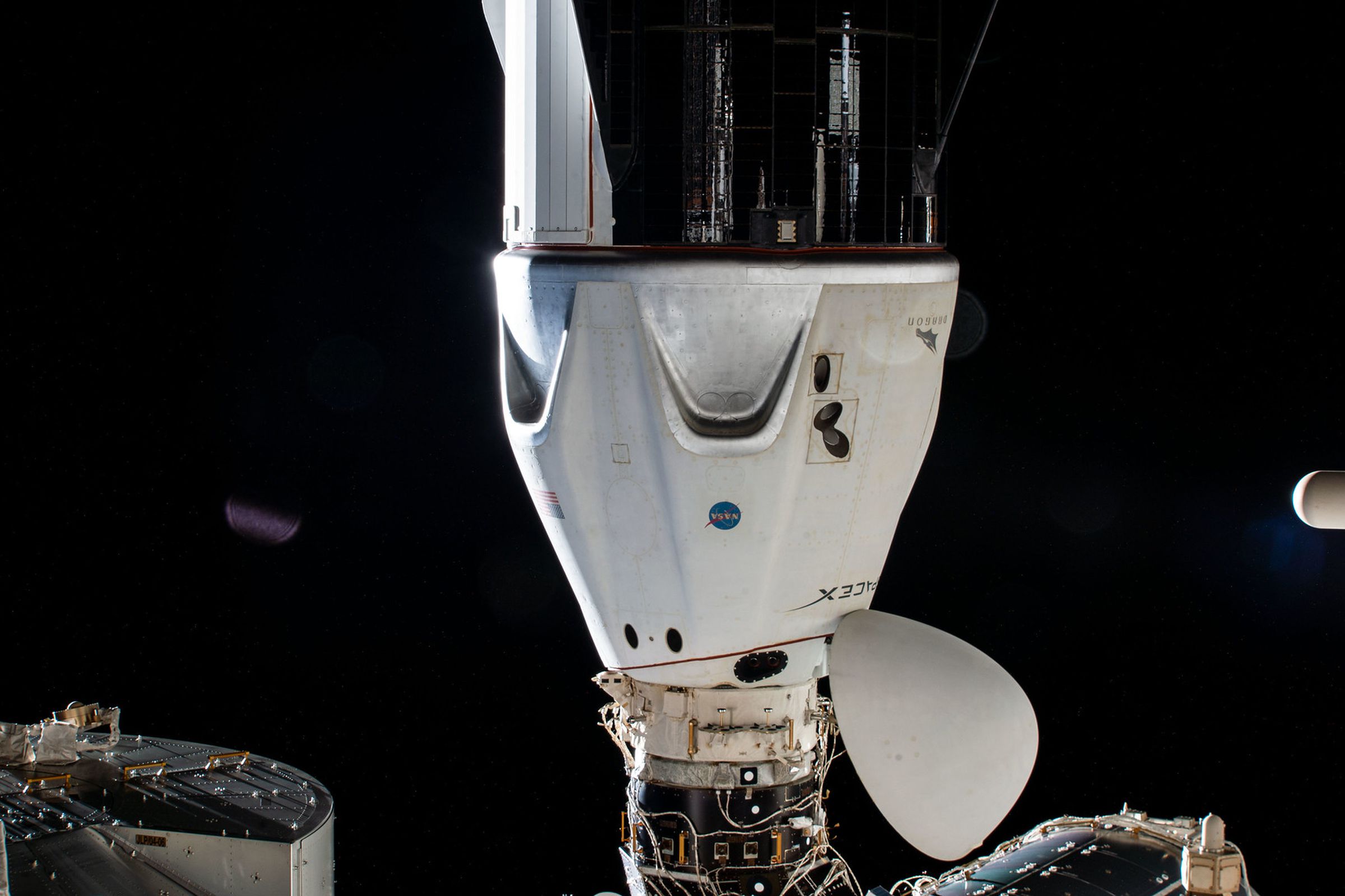 SpaceX’s Crew Dragon capsule is seen docked to the ISS in April, 2021 after a port relocation manuever with its crew of four Crew-1 astronauts on board.