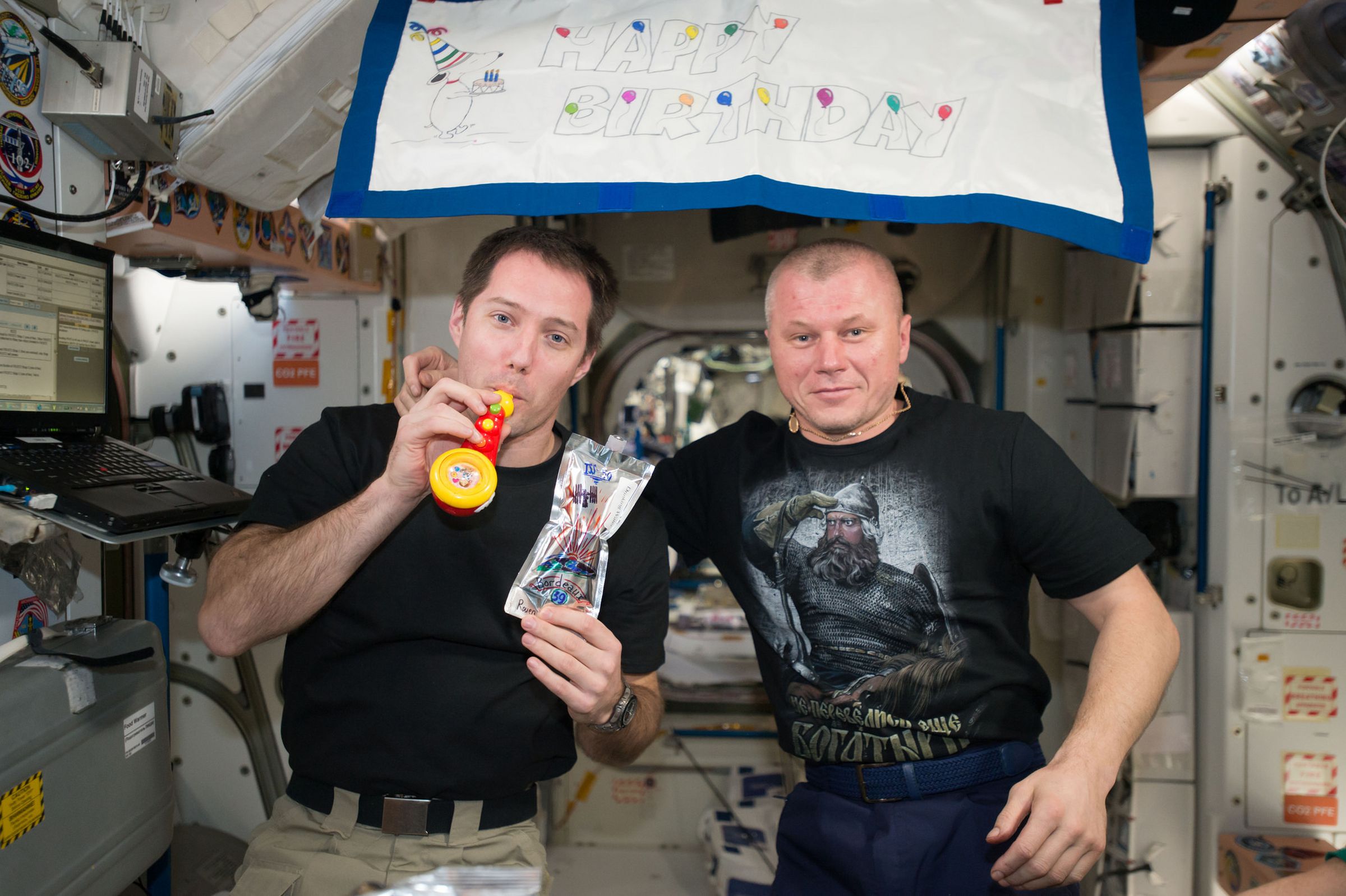 Thomas Pesquet of the ESA and Oleg Novitskiy of Roscosmos celebrate Pesquet's birthday aboard the International Space Station.