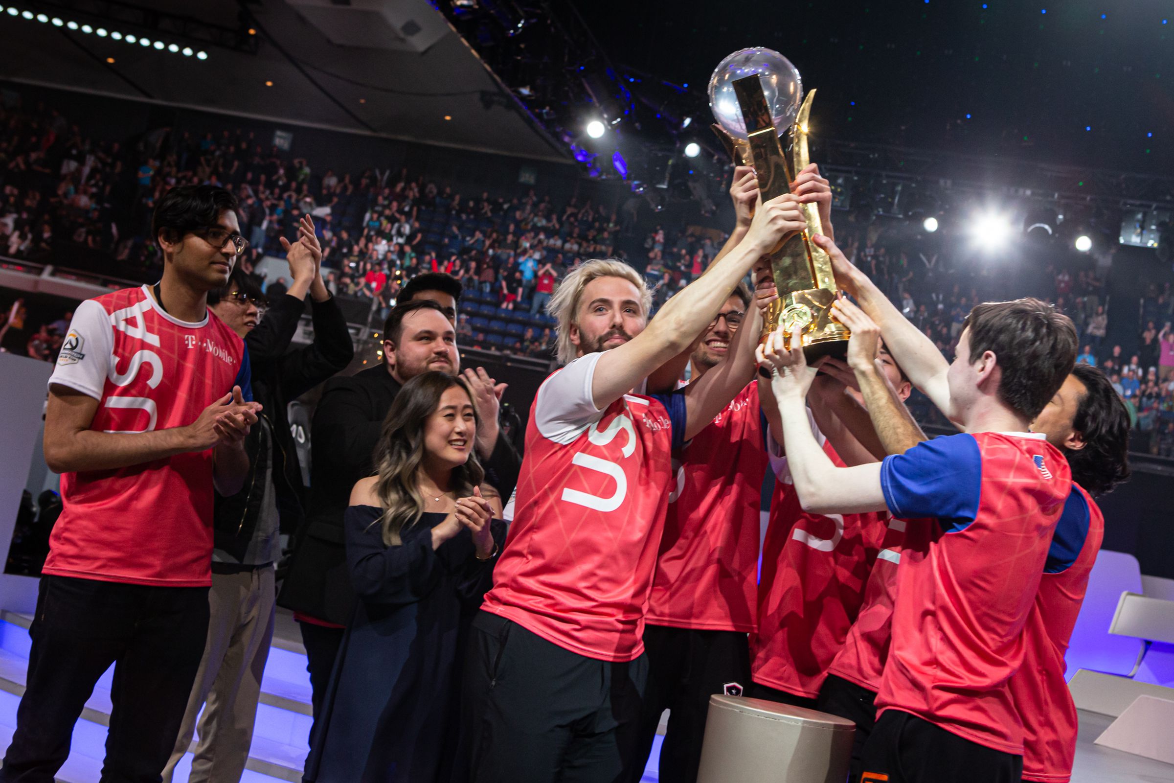 Photo from 2019 Overwatch World Cup in which the gold medalist team, the US, hold up the World Cup trophy.