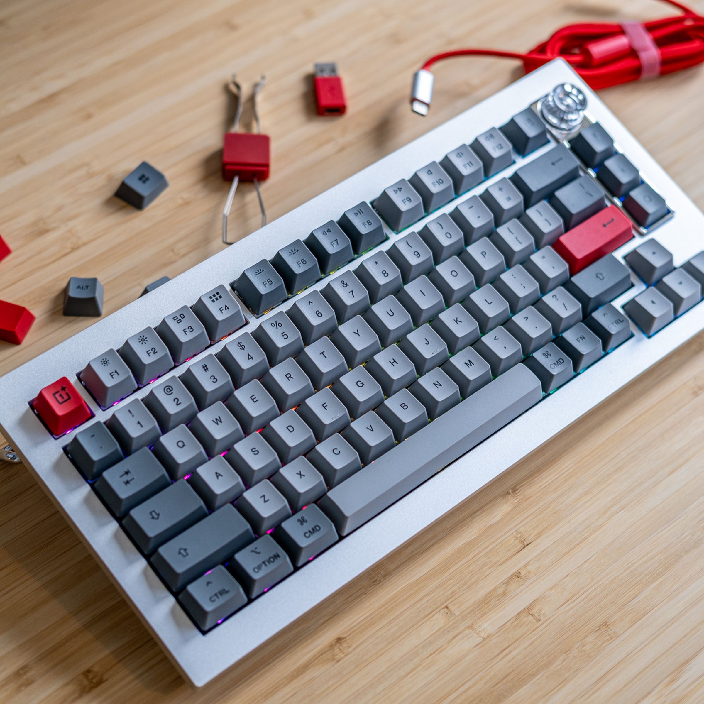 OnePlus keyboard on desk surrounded by accessories.