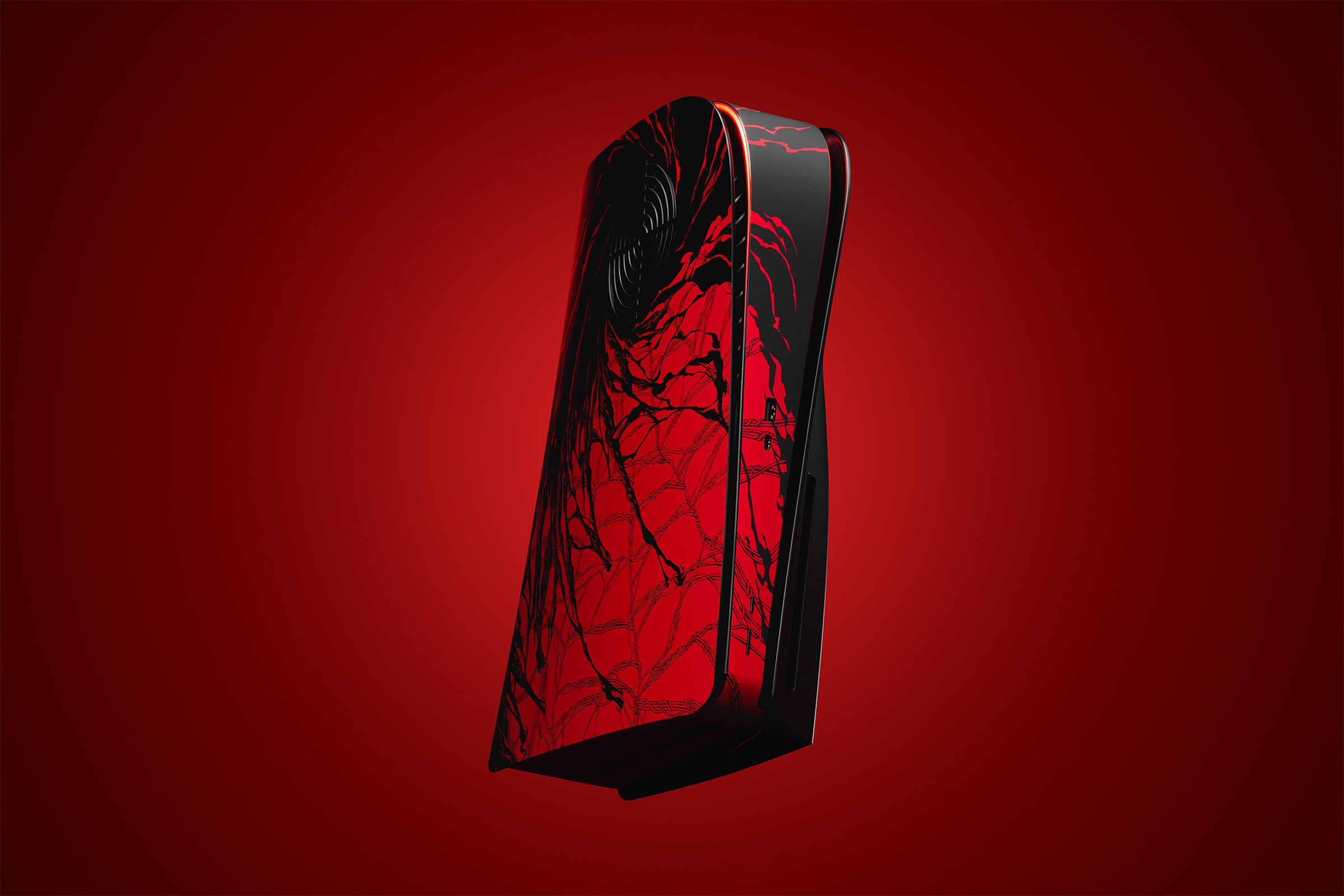 A black and red PS5 with creeping webs and dark matter.