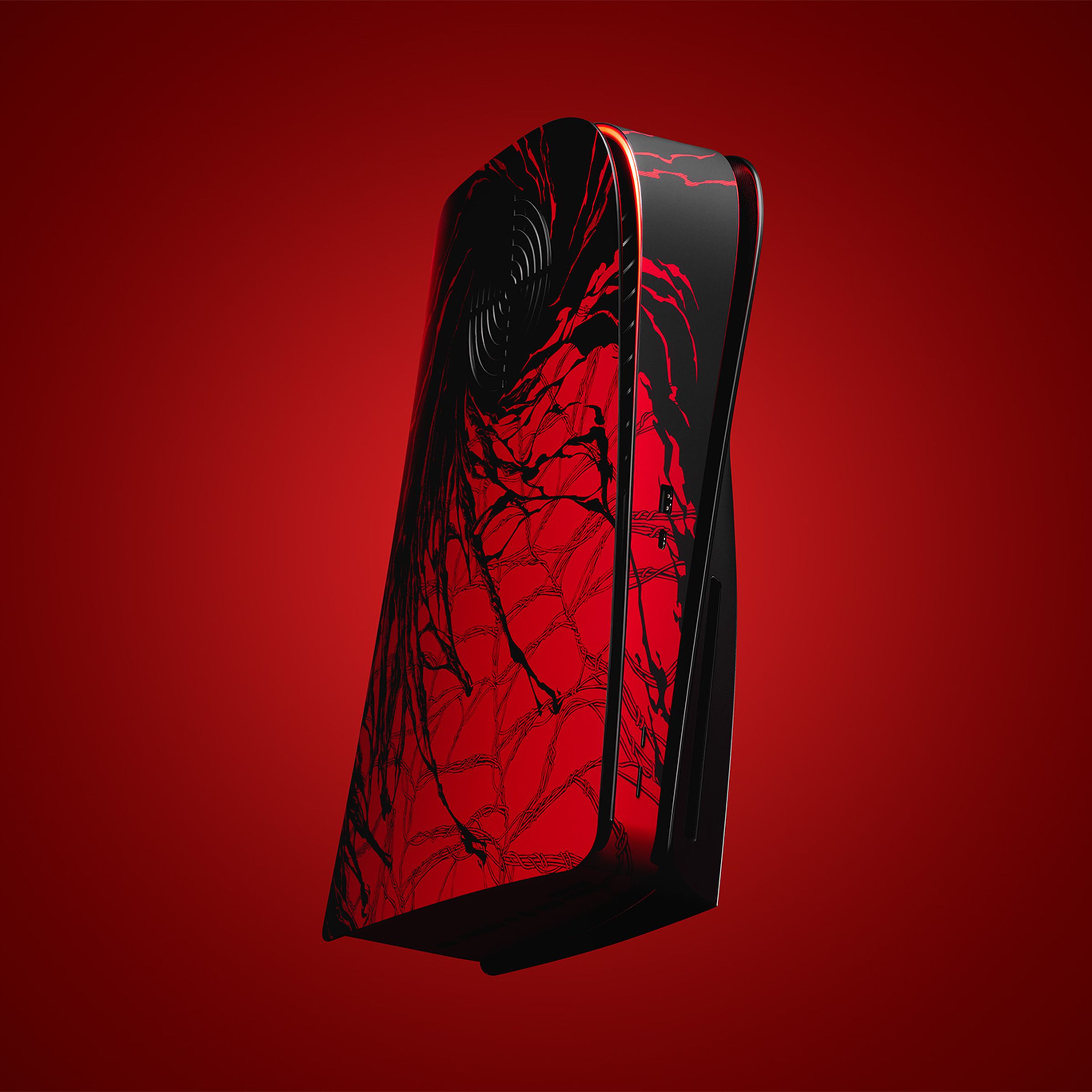A black and red PS5 with creeping webs and dark matter.