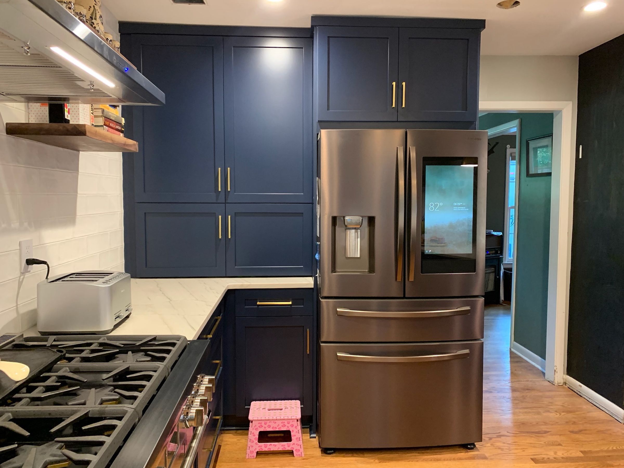 A close-up of a stainless steel fridge with a screen.