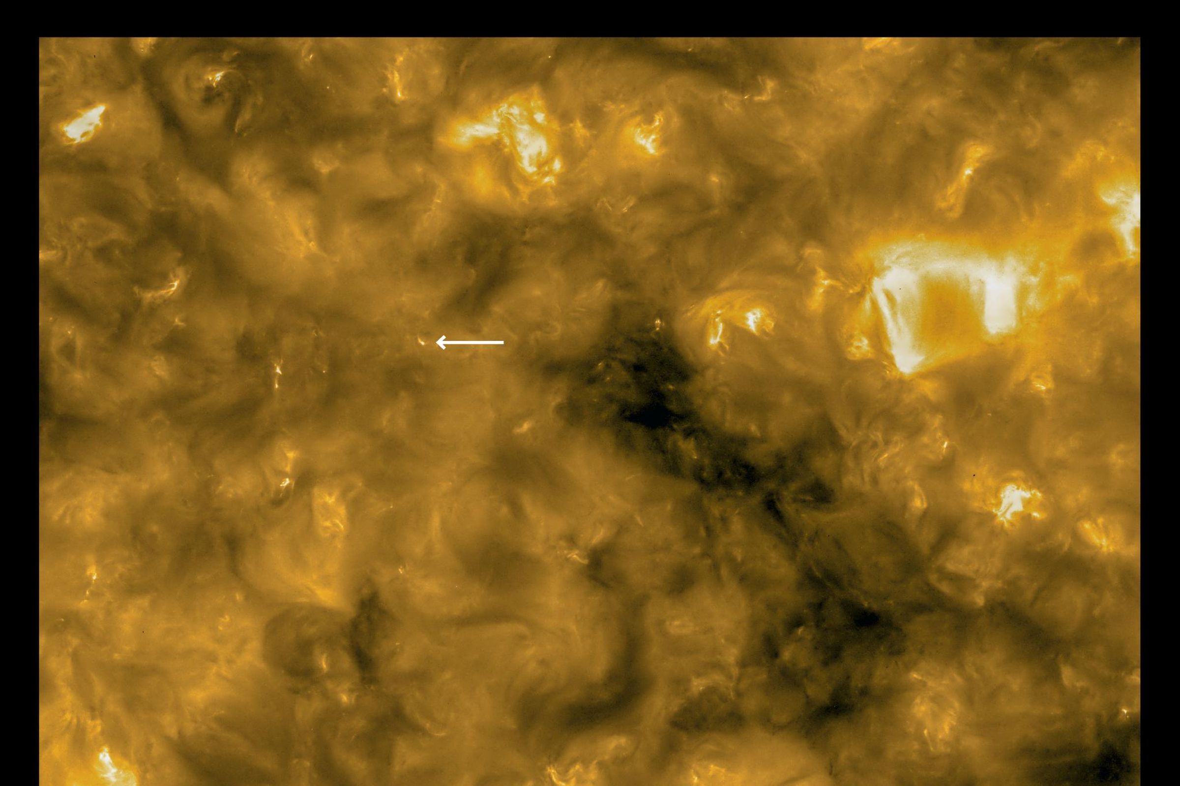 A high-resolution image from Solar Orbiter, with an arrow pointing to one of the campfires