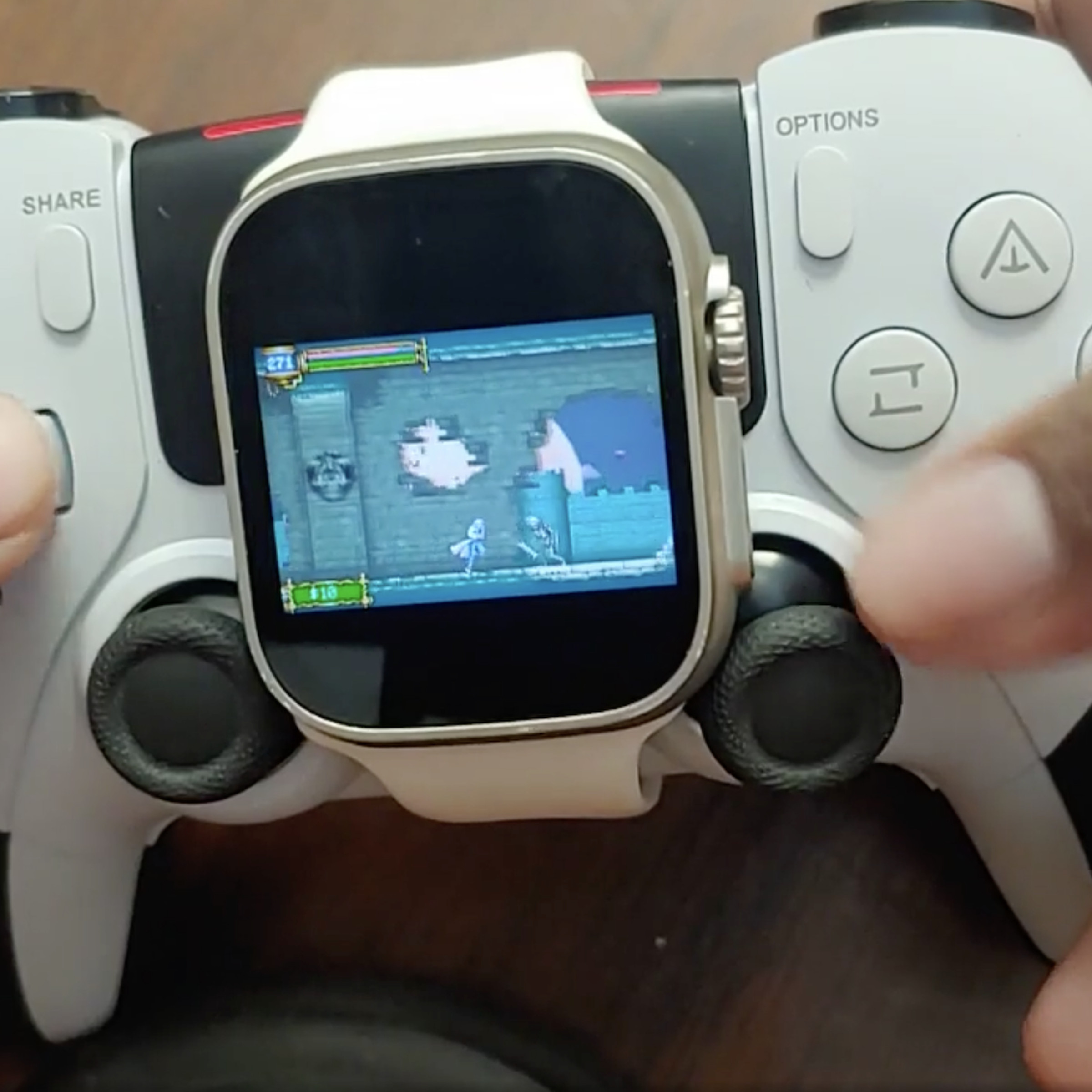 An image of a person playing a Castlevania game on a smartwatch, strapped to a controller.