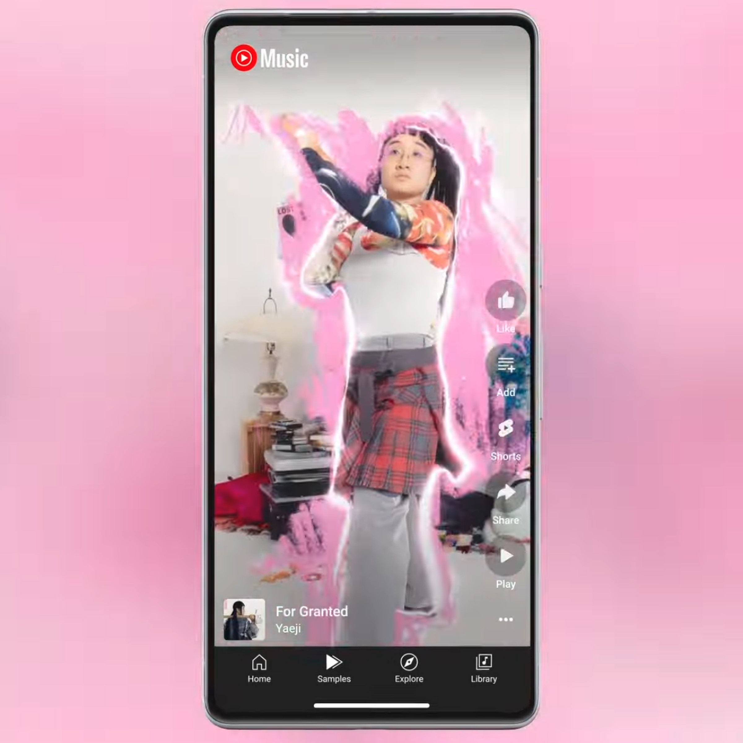 A screenshot of a music video playing in the YouTube Music app, on a pink background.