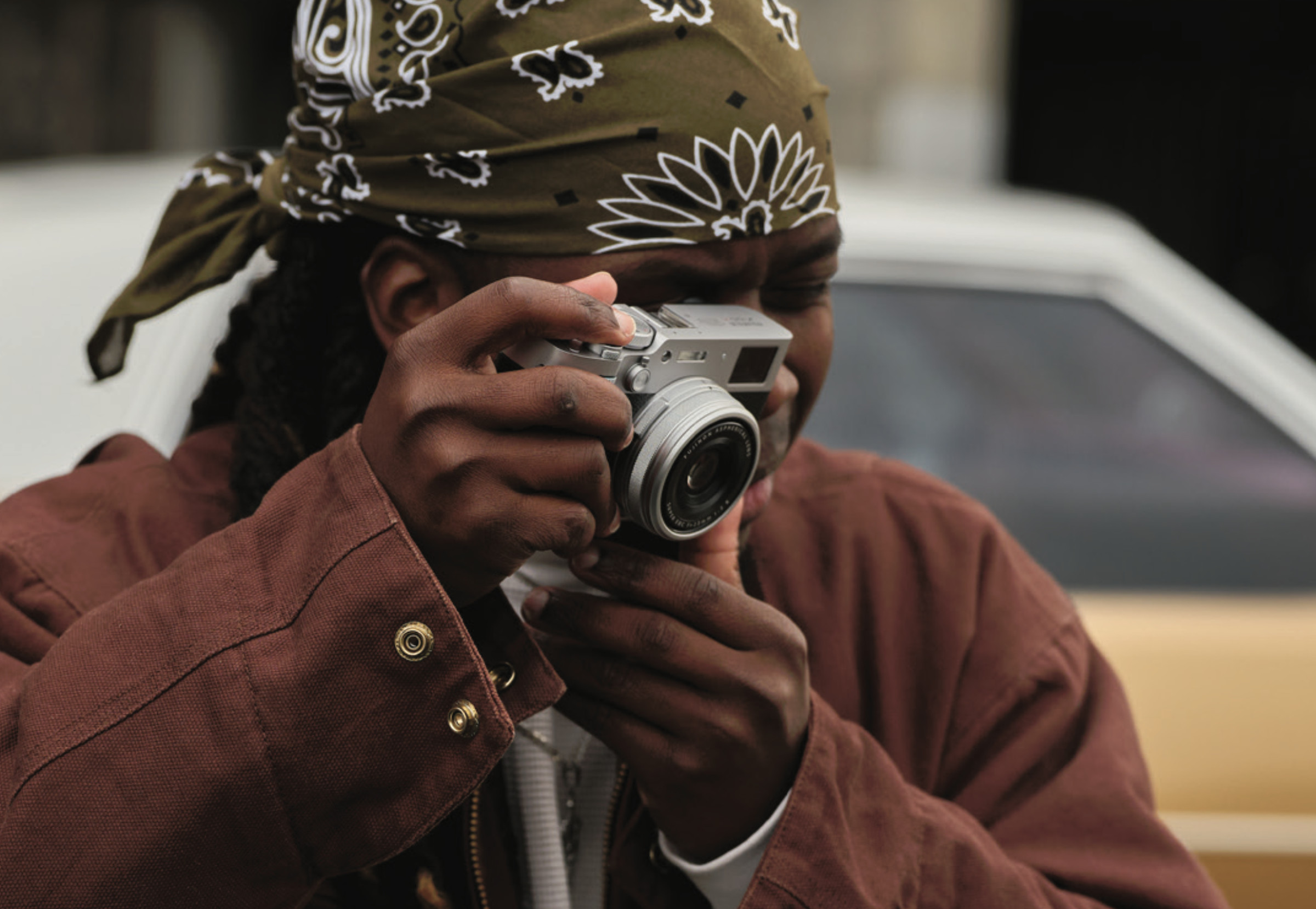 A photo of a person shooting with Fujifilm’s X100VI camera.