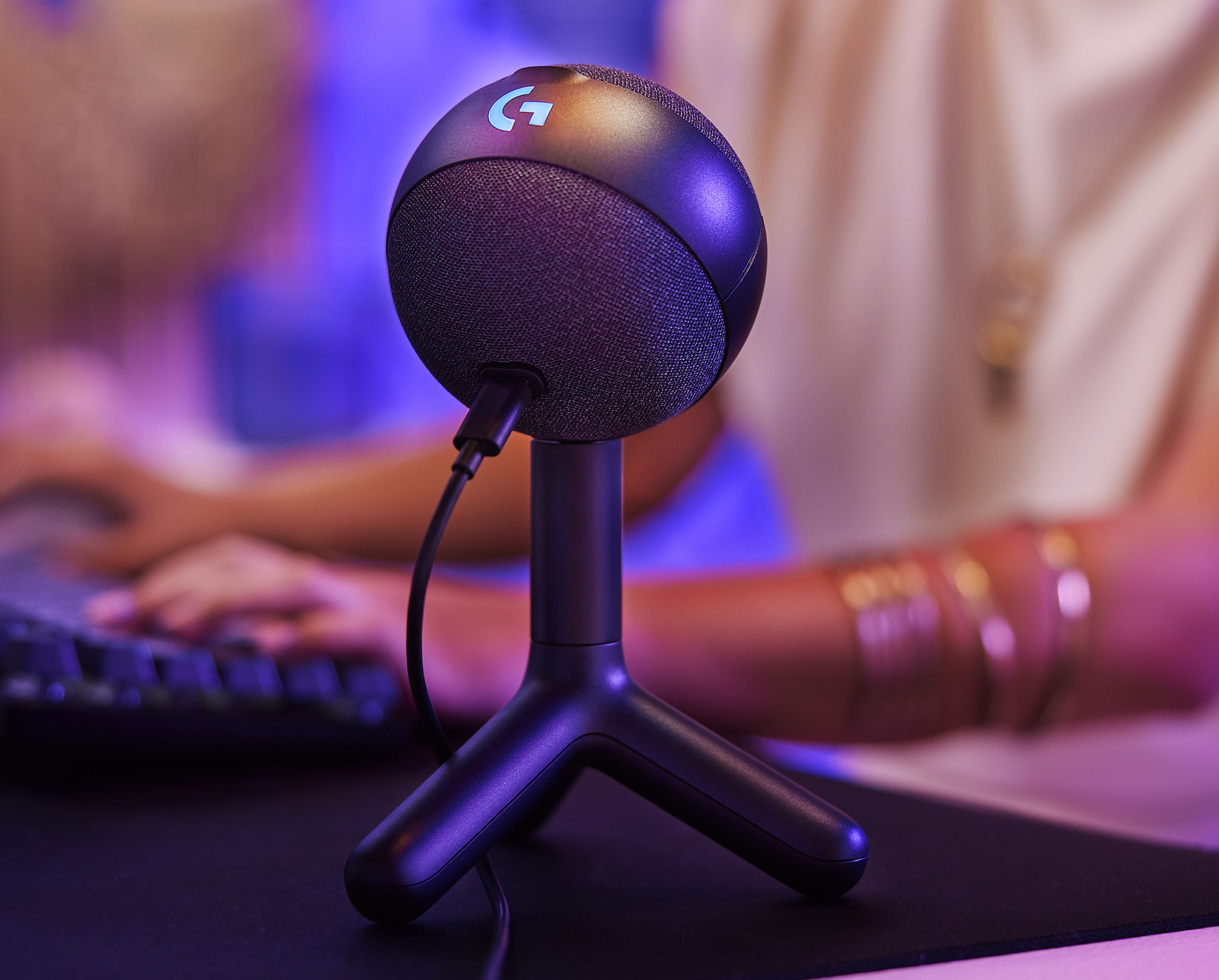 A picture of the Logitech Orb sitting on its small stand, which looks like a chicken’s foot.