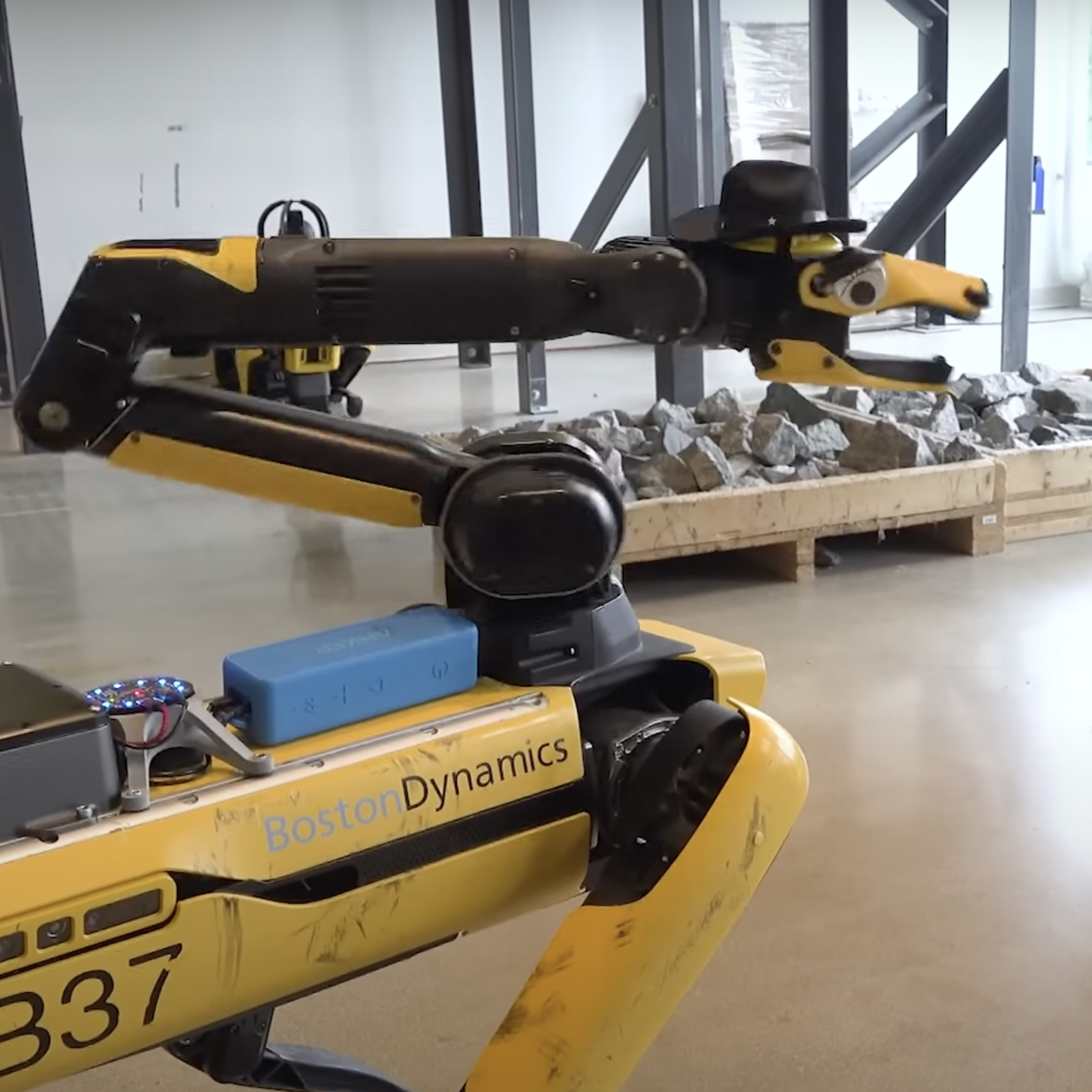 An image showing Boston Dynamics’ Spot robot with a top hat and googly eyes