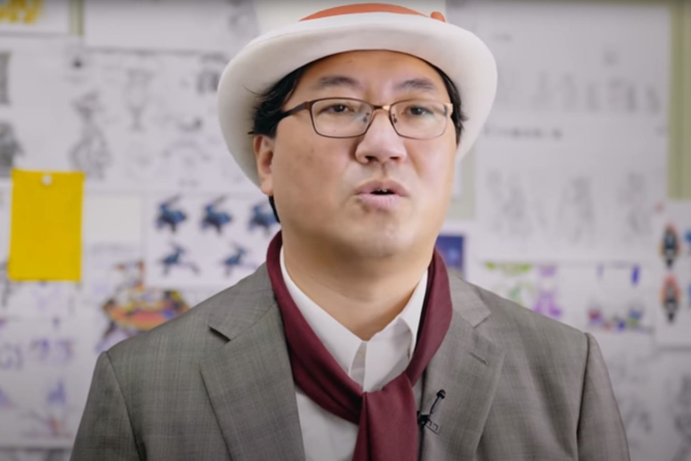 Yuji Naka in a white tophat and grey suit