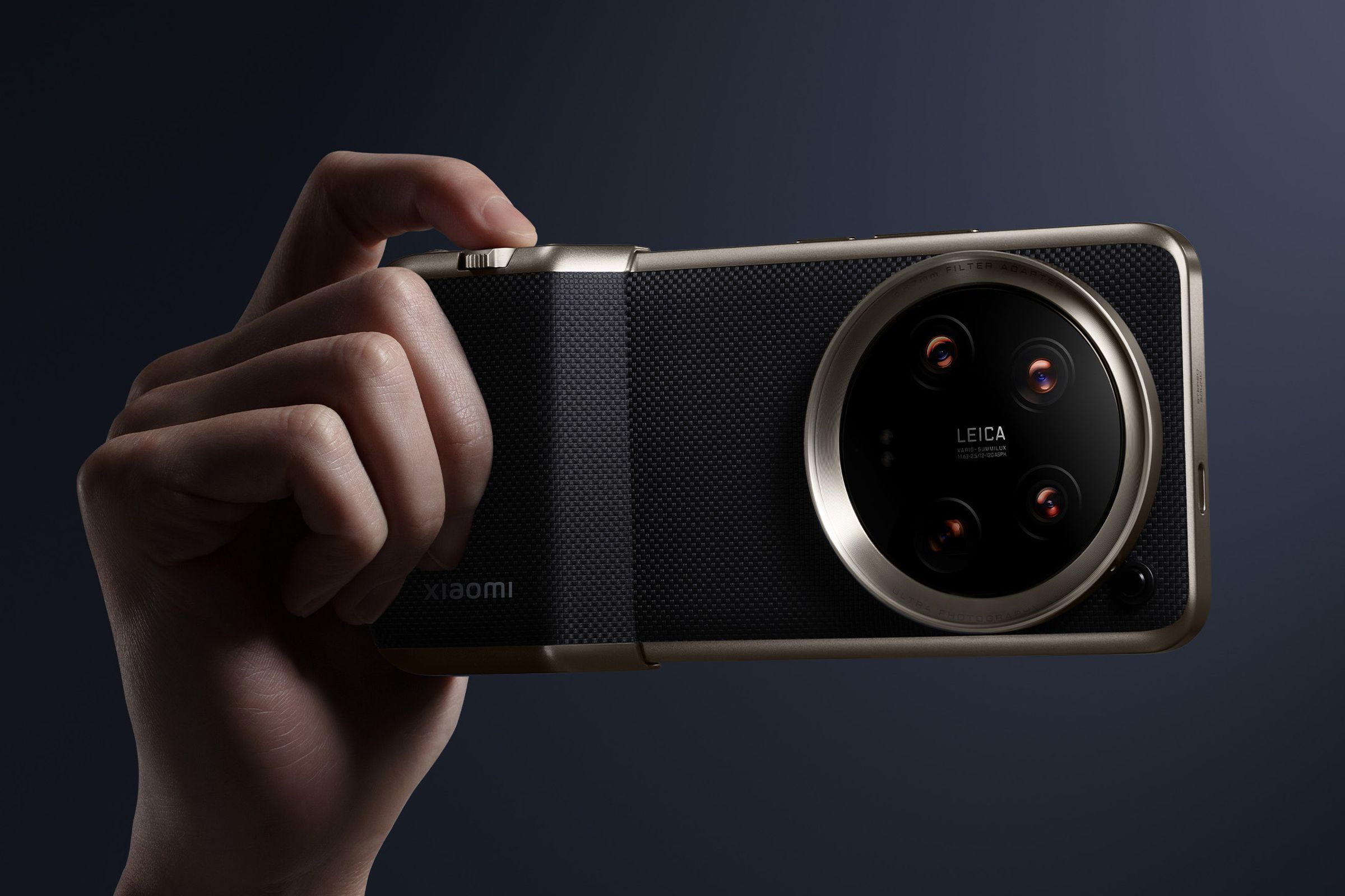 Xiaomi 14 Ultra held in the hand with camera grip and shutter button.
