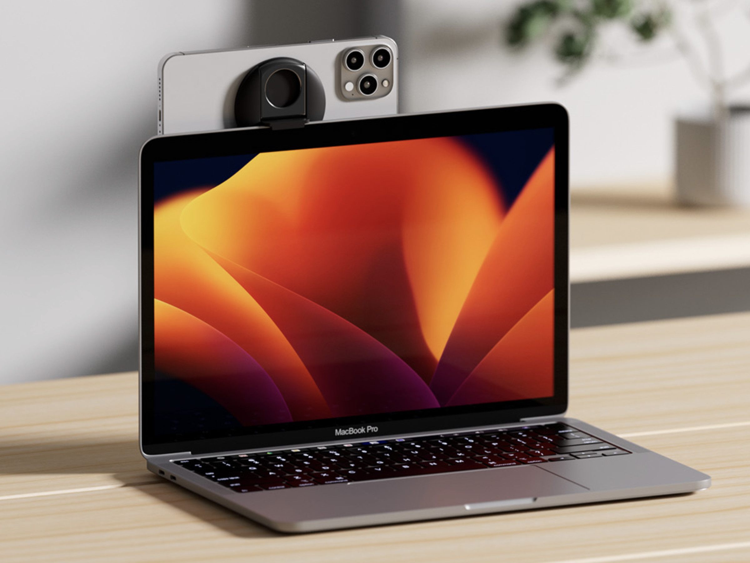 Photo of the Belkin iPhone mount on top of a MacBook Pro.