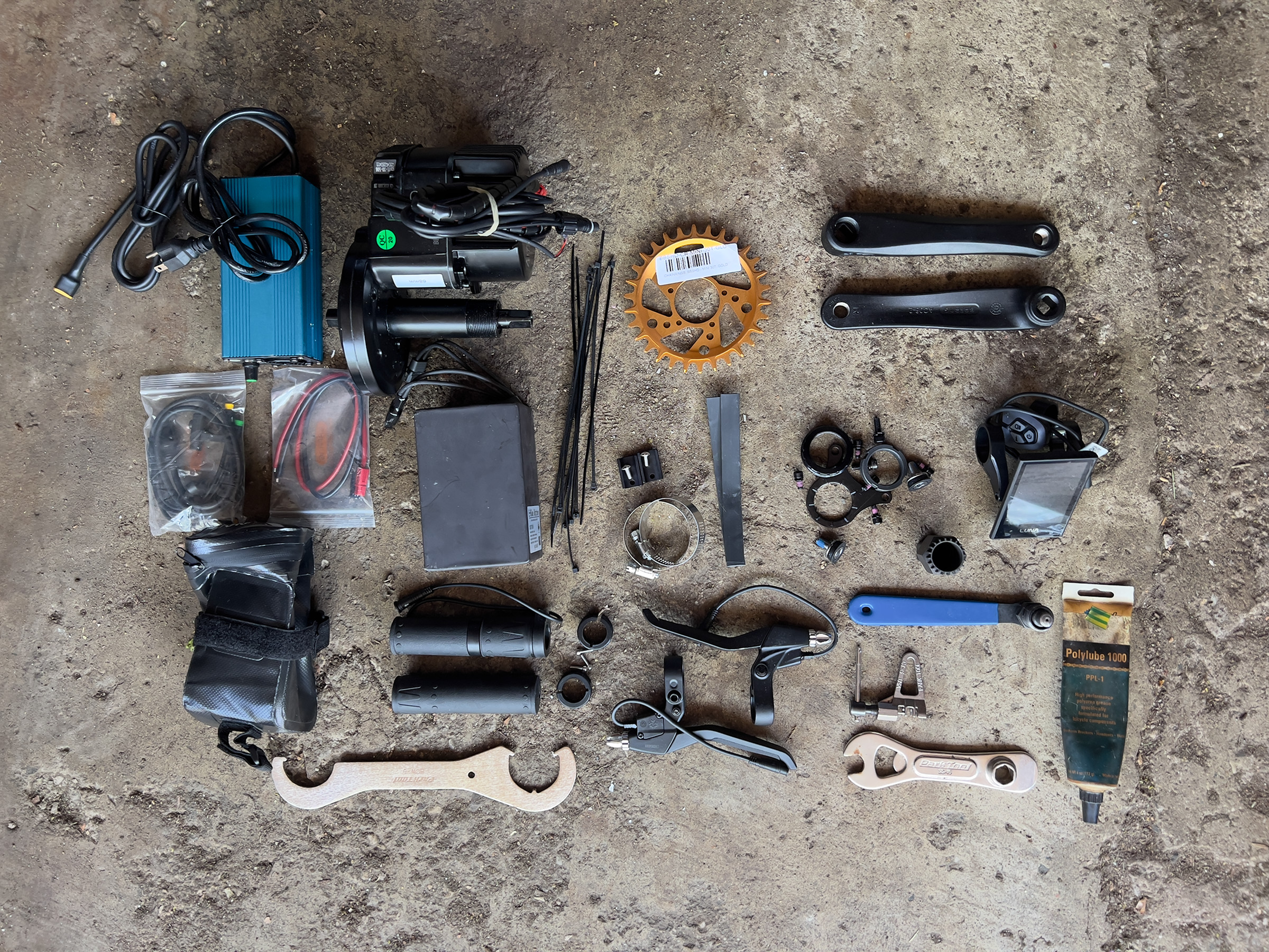 A picture of several of the tools and parts used in the build, laid out on the ground.