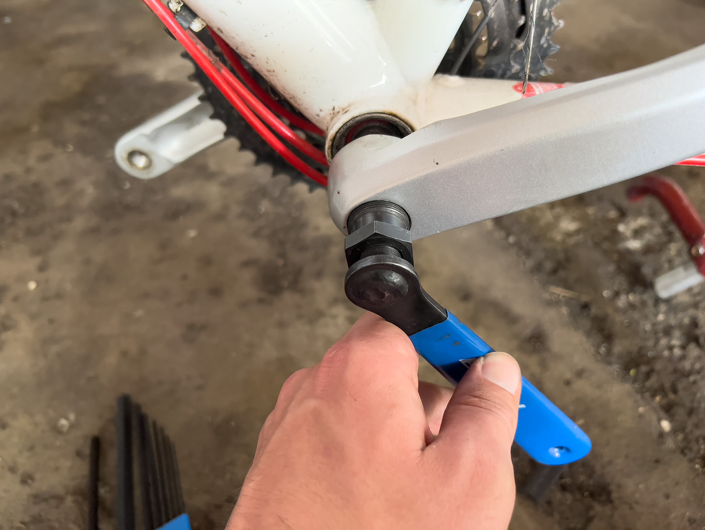 A picture of a crank puller being used to remove the non-drive-side crank arm.
