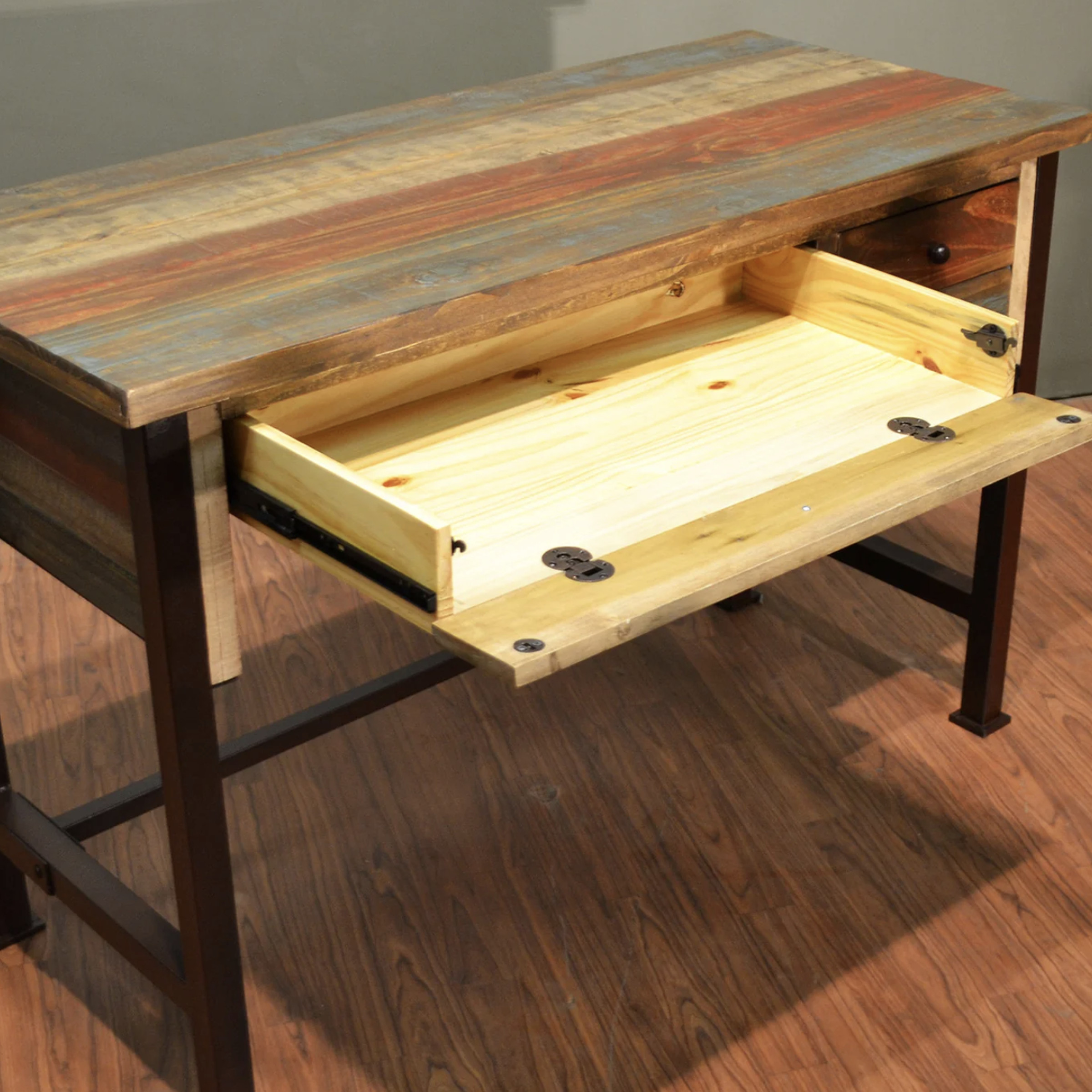 Wooden desk with open drawer.