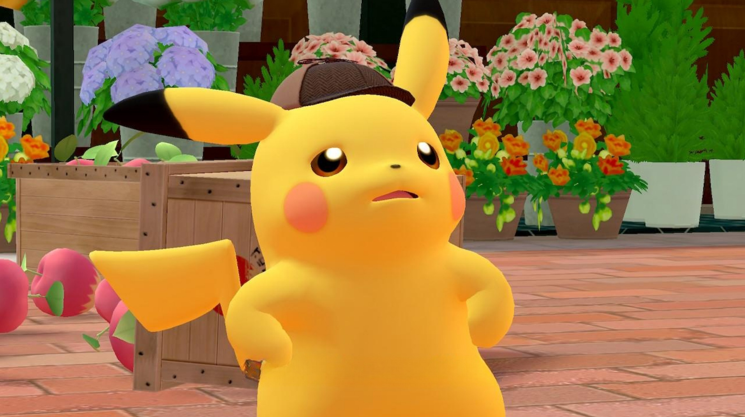 A pikachu wearing a detective’s hat, and standing with his paws on his hips in front of a couple of overturned apple crates.