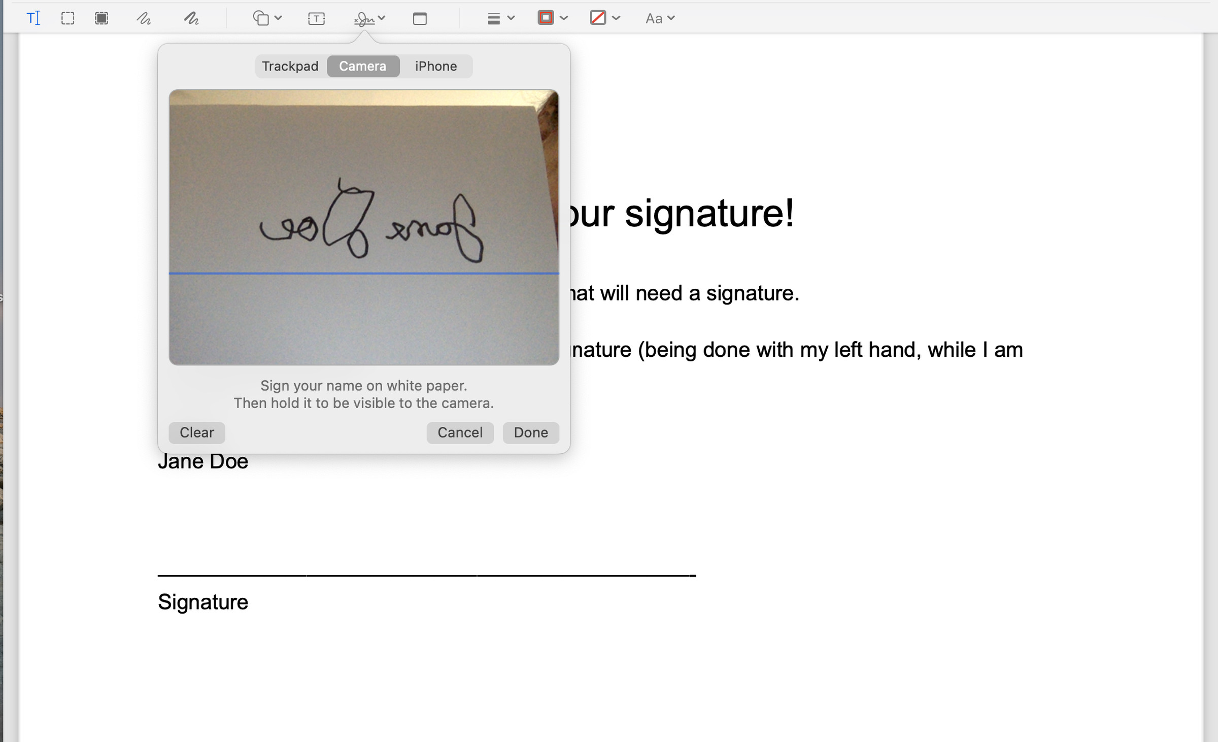 As you hold your written signature up to the camera, it will appear reversed
