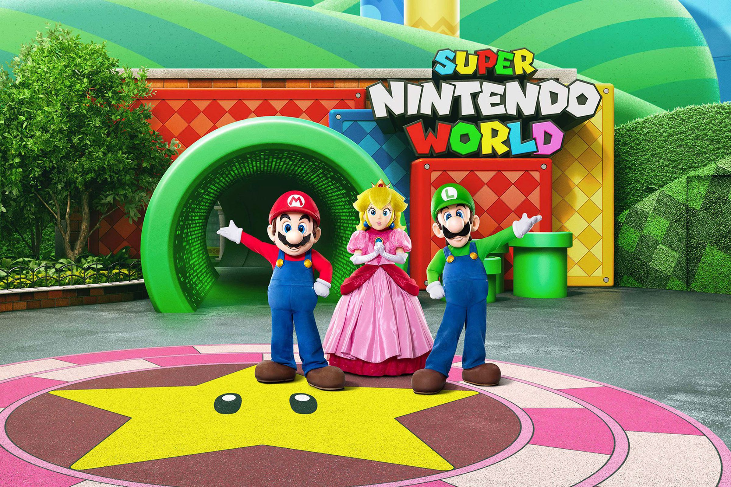 Image shows figures of Mario, Princess Peach, and Luigi standing in front of a life-size Mario tunnel and massive “Super Nintendo World” sign.