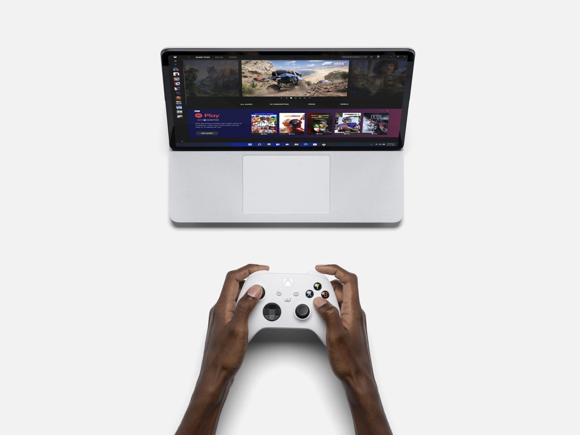 A Surface Studio laptop with an Xbox controller