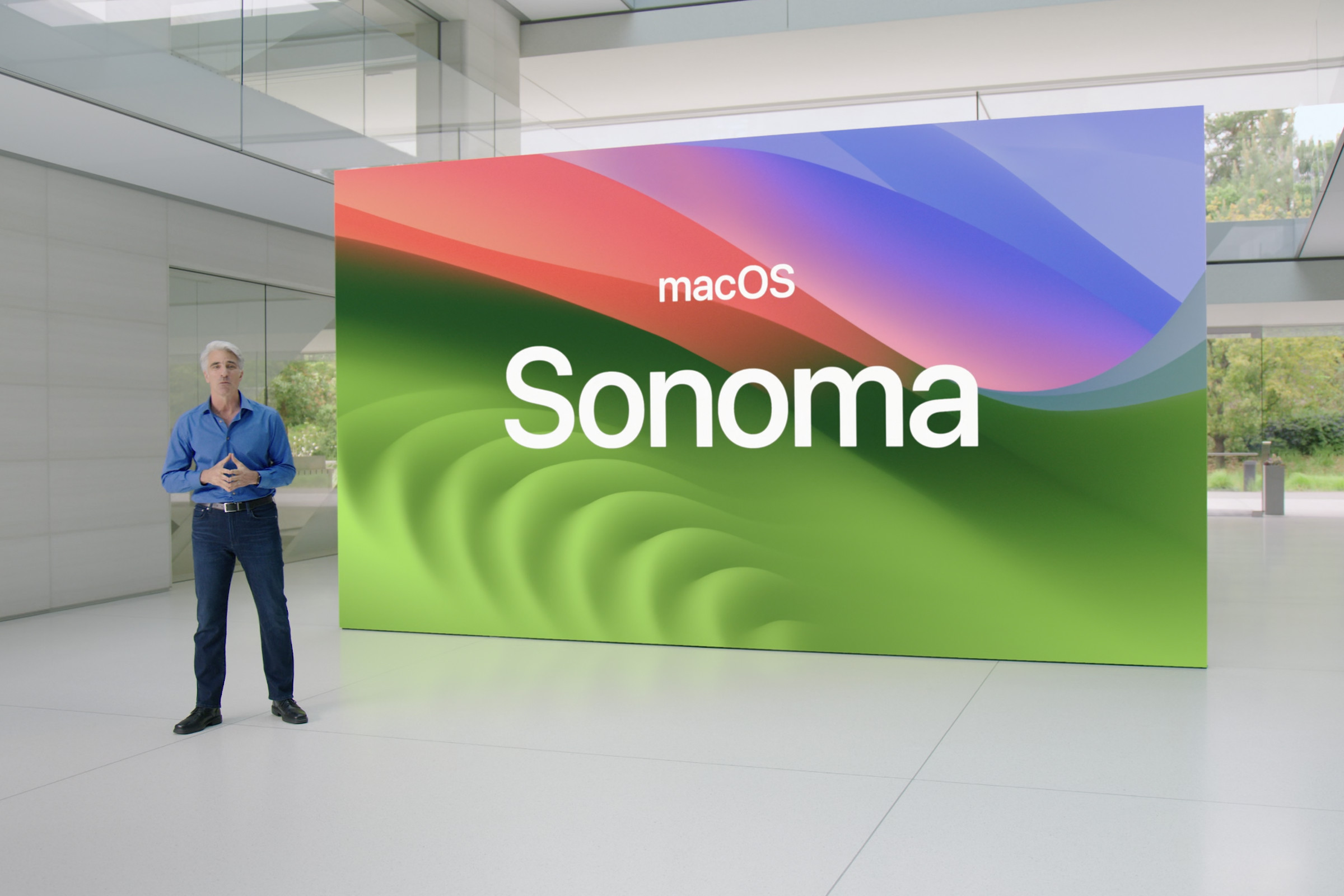 Apple executive Craig Federighi stands in front of a macOS Sonoma slide.
