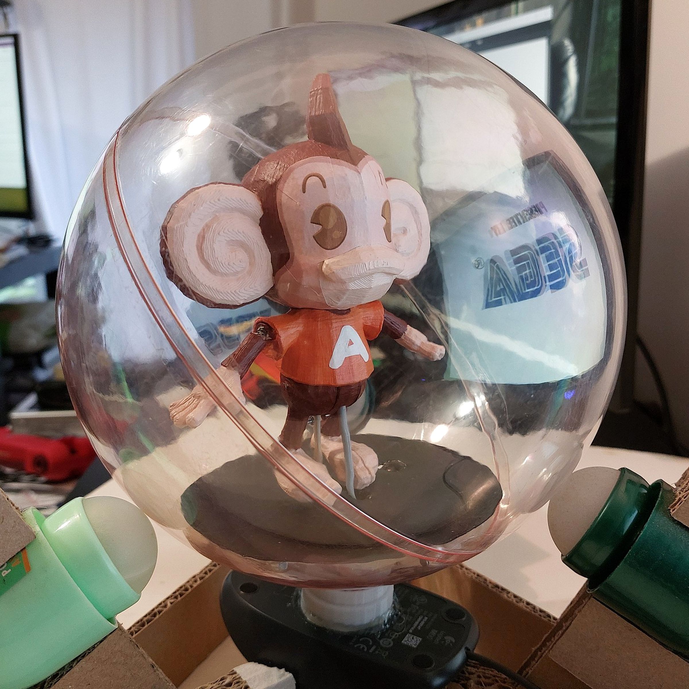 A close-up of the 3D-printed monkey in a plastic sphere controller created by Tom Tilley.