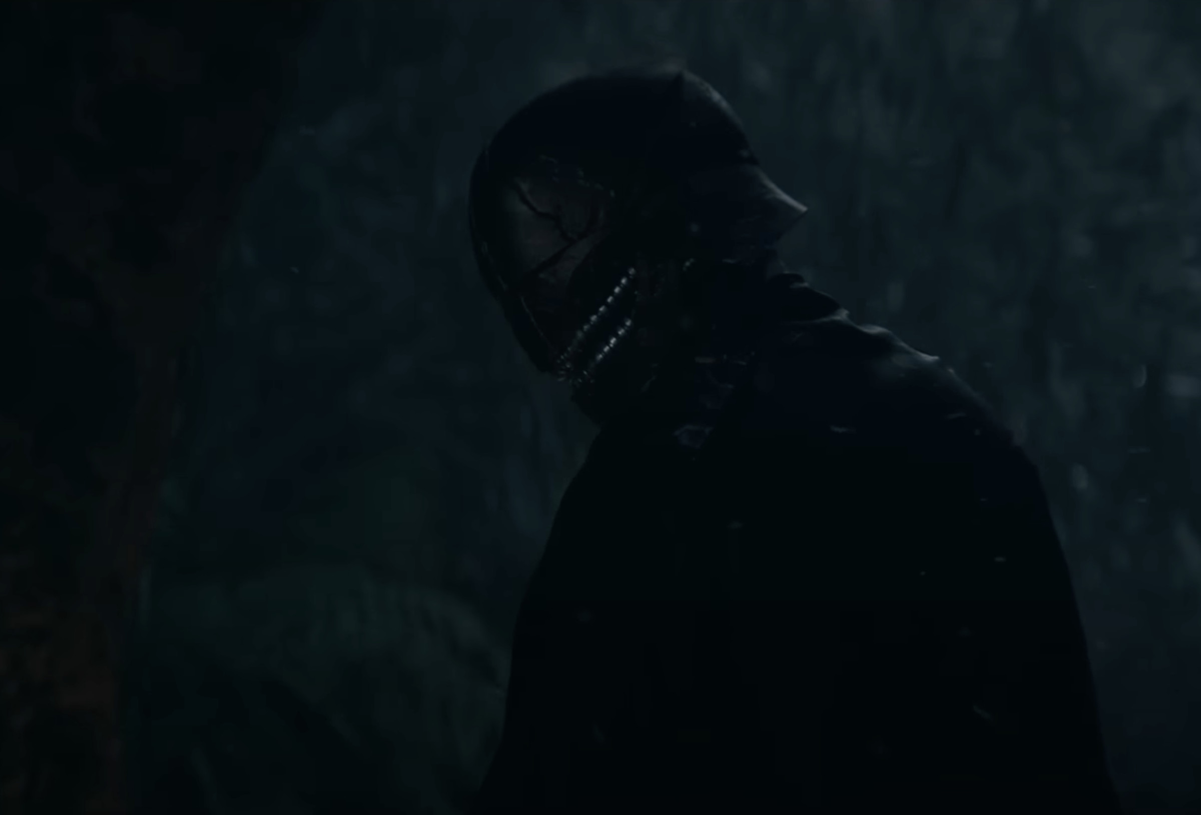 A screenshot shows the new villain, who wears a helmet that has two rows of zipper-like teeth on the lower half.