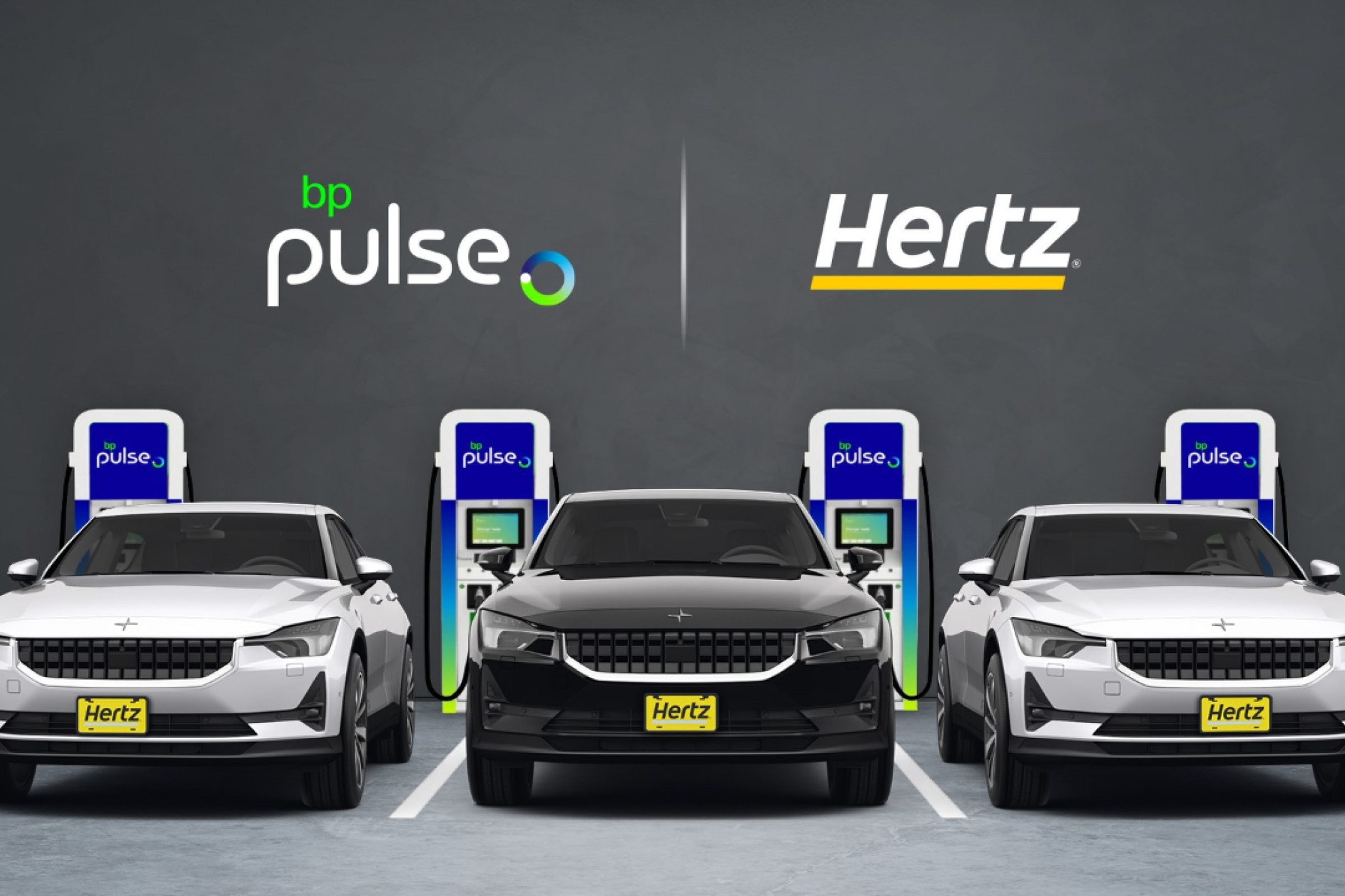 A line of Hertz-owned electric vehicles at chargers