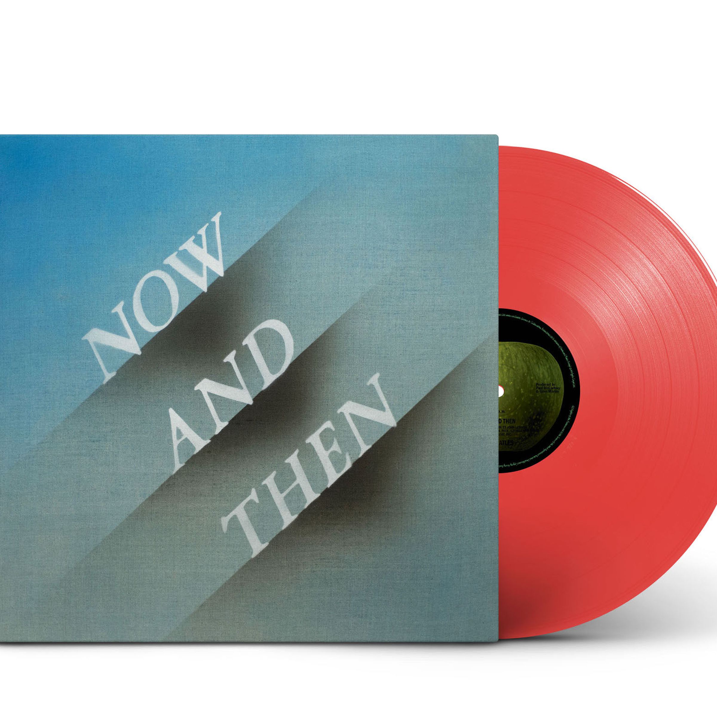 An album cover that reads “Now and Then” along with a red vinyl record with a black center. Both are standing up against a white backdrop.