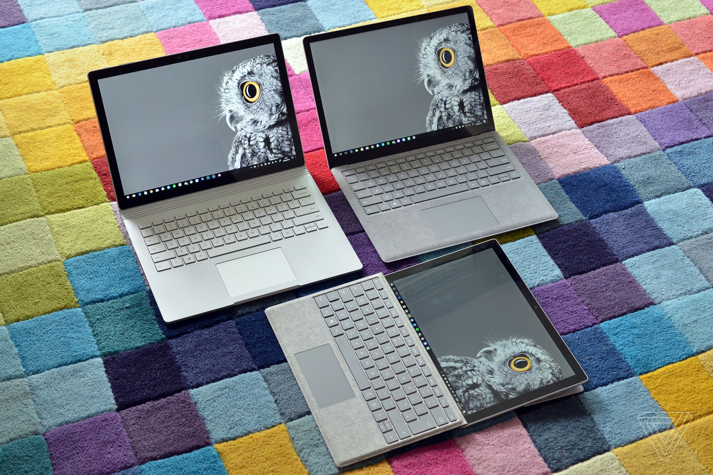 A photo of multiple Surface devices on a colorful rug