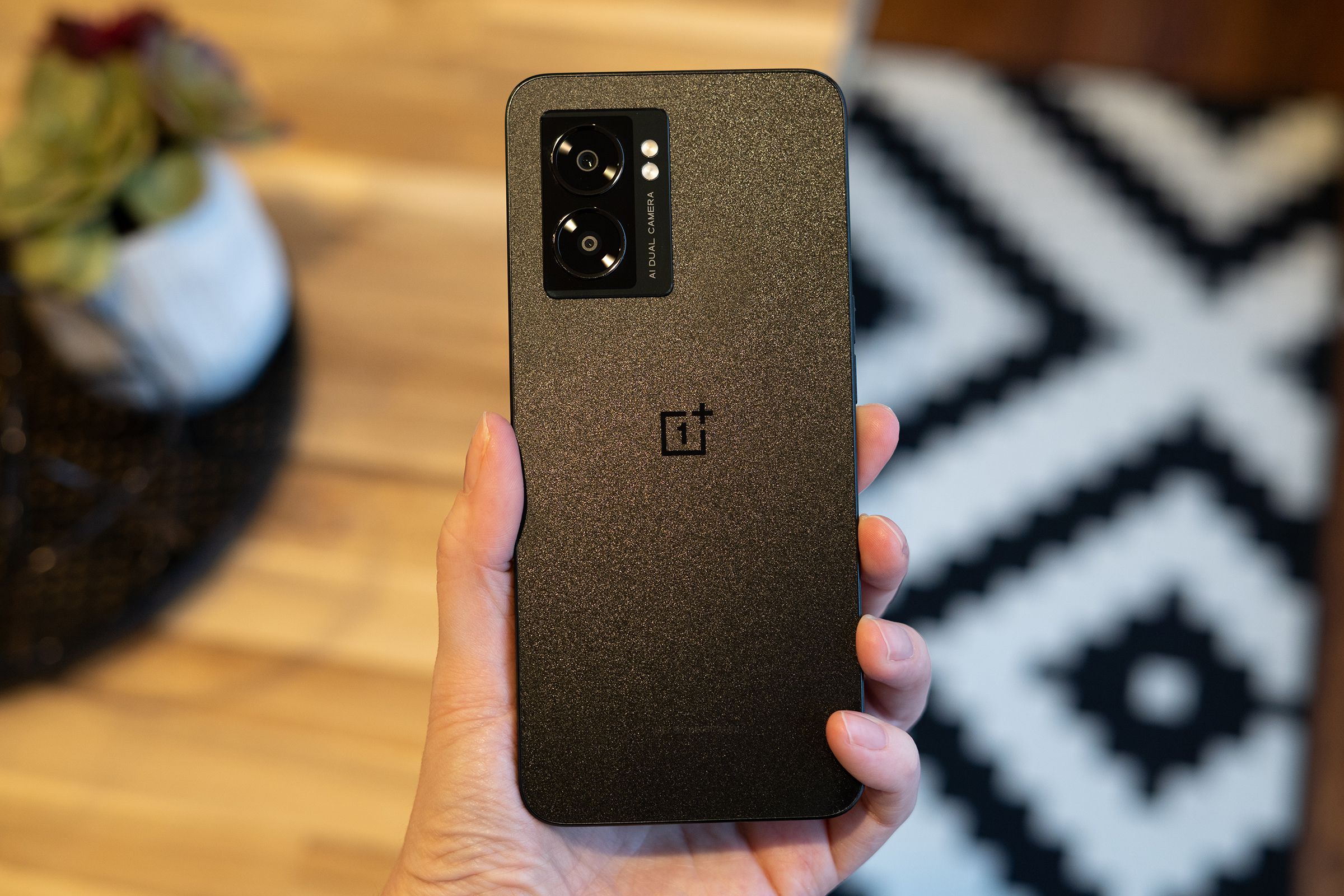 OnePlus N300 in hand showing back panel.