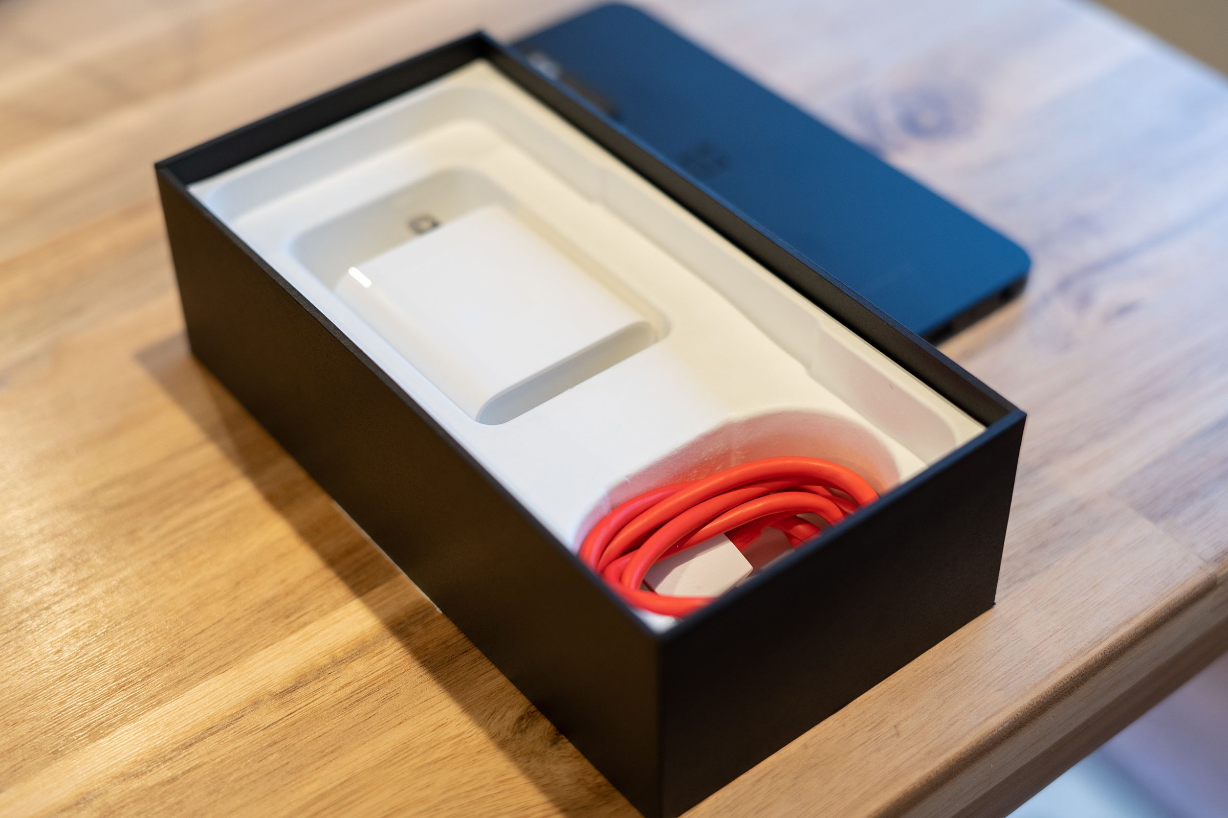Charger and cable shown in a retail box with no lid
