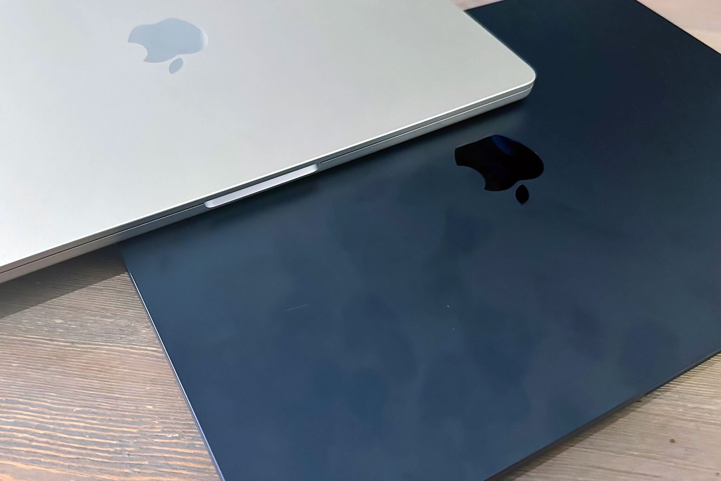 Image of a champagne-colored MacBook overlapping a smudged dark navy MacBook.