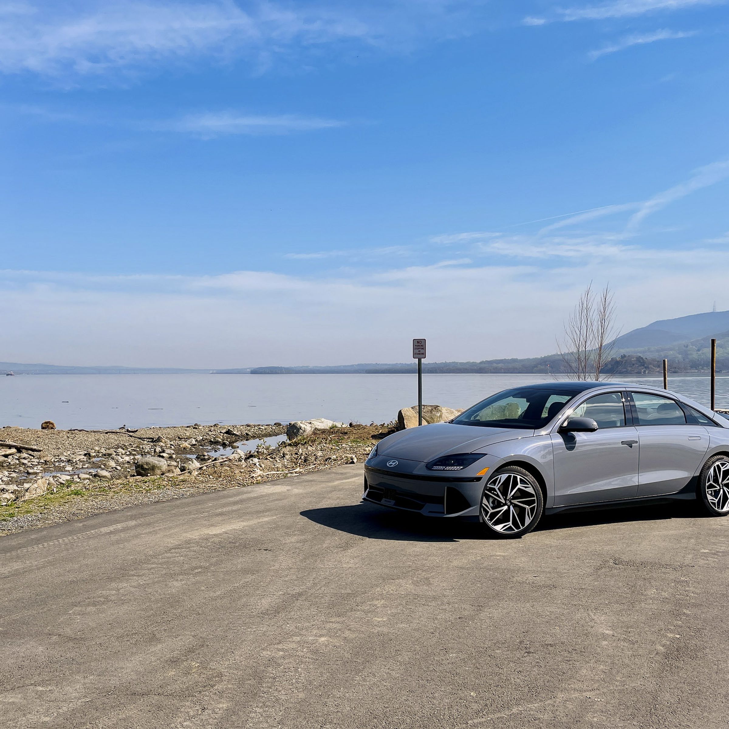 A Hyundai Ioniq 6 parked in front of a body of water