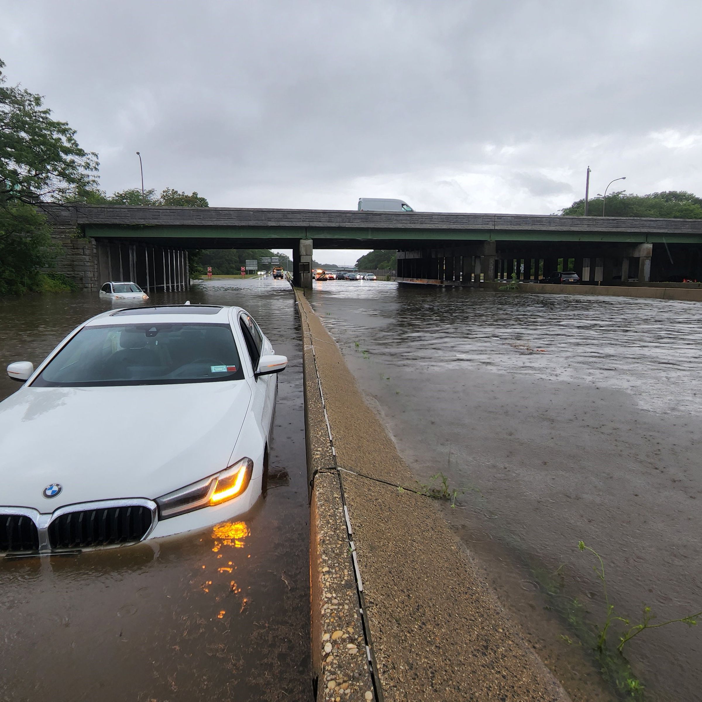 Cars are stranded in a flood on Sunrise Highway at the Heckscher State Parkway interchange in Islip Terrace, New York on July 16, 2023