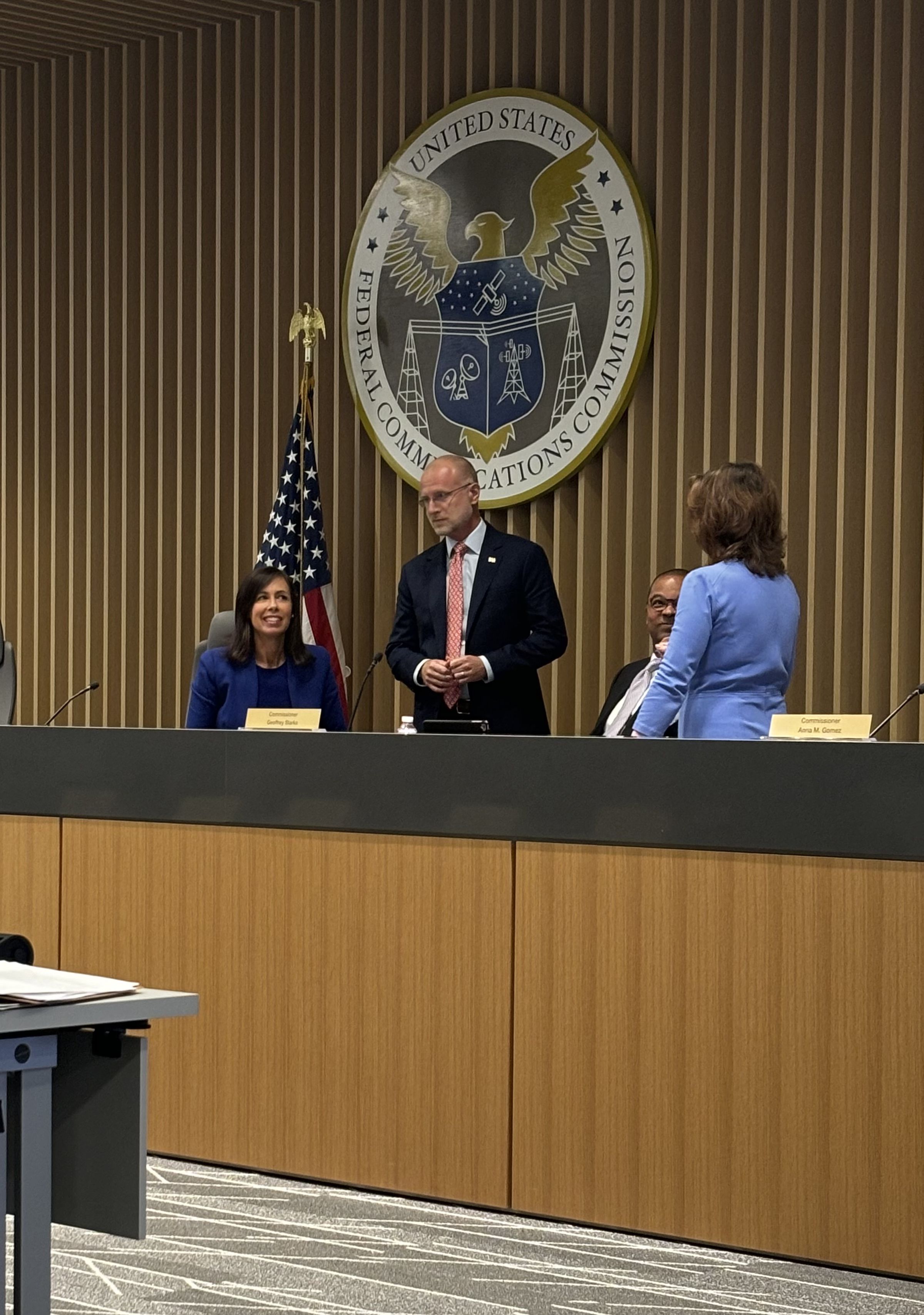 Four FCC commissioners chatting before voting on a new net neutrality notice of proposed rulemaking.