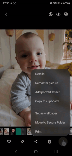 Gif showing the remastering process seemingly adding teeth to a baby photo.