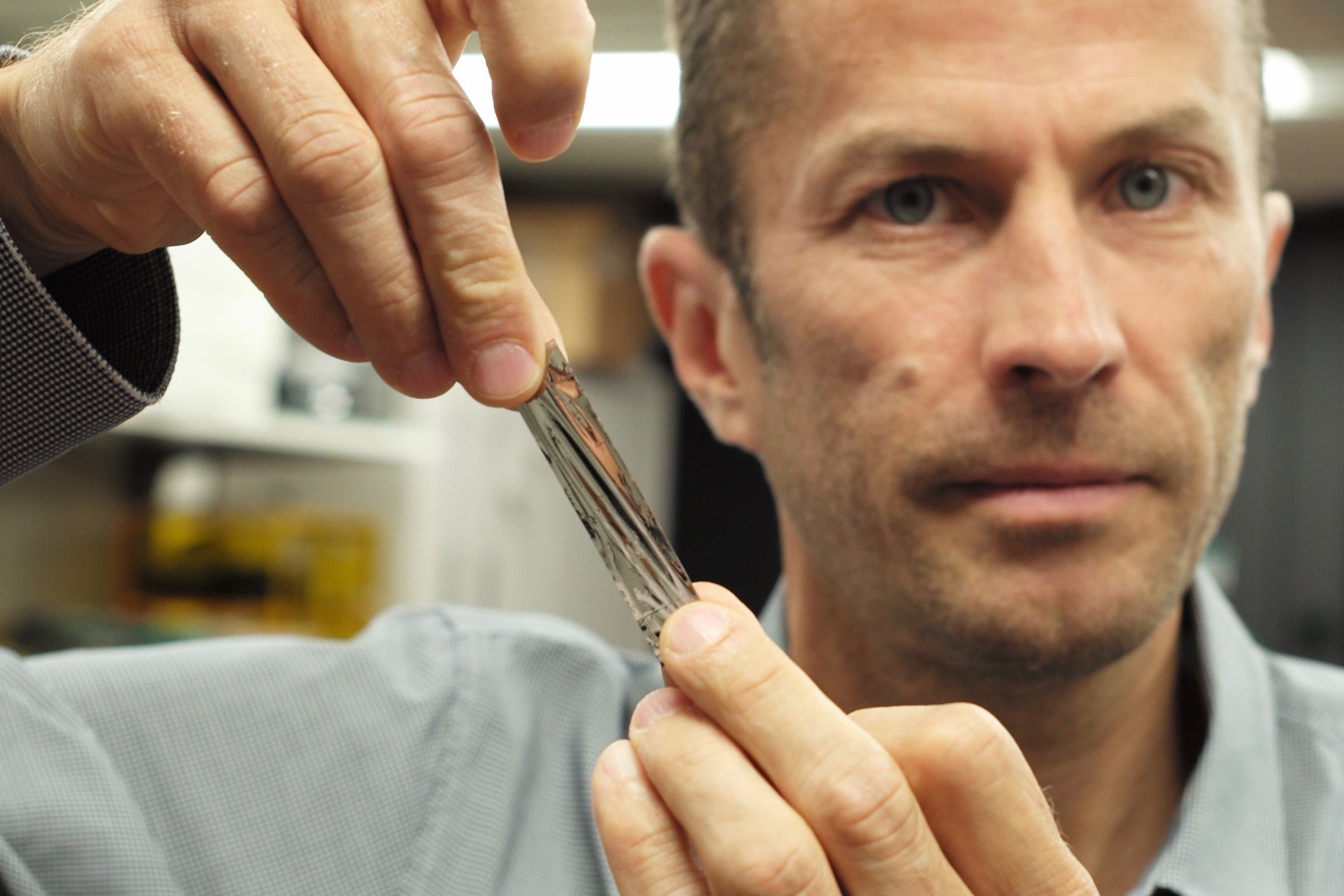 IBM scientist Dr. Mark Lantz, holds a one square inch piece of sputtered tape, which can hold 201 Gigabytes, a new world record.