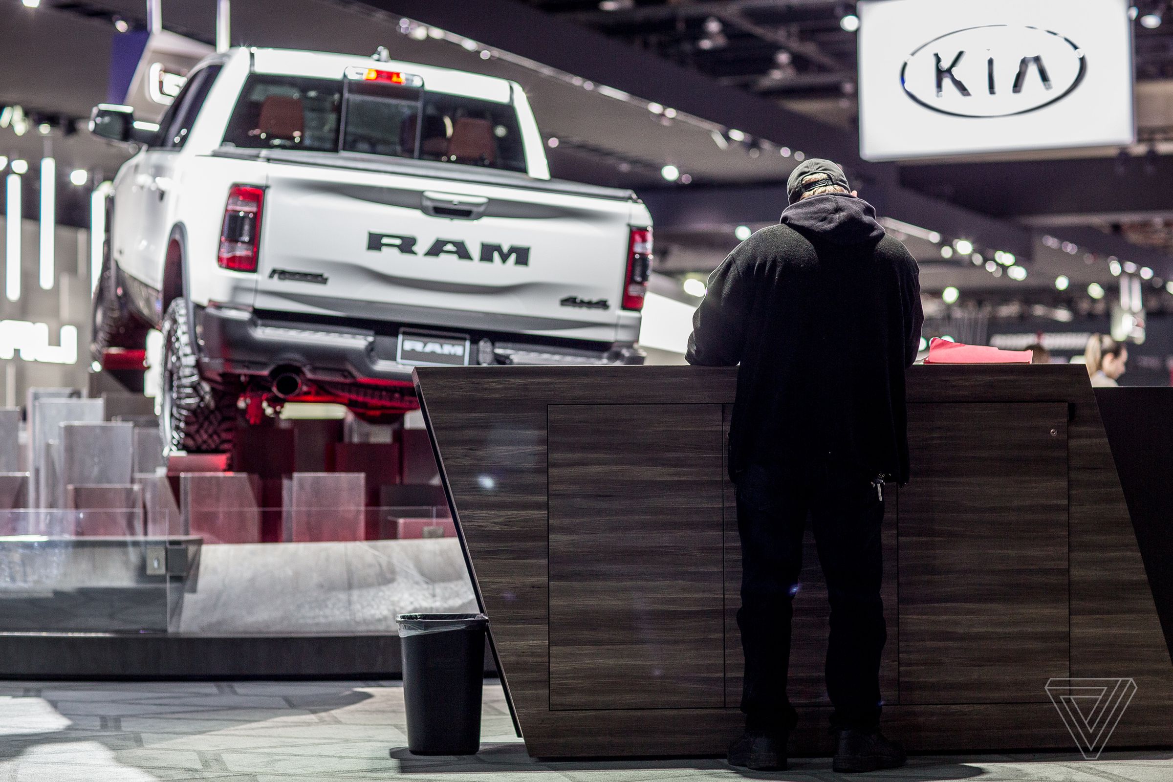 A worker plans out some of the mid-show changes to the FCA booth. 