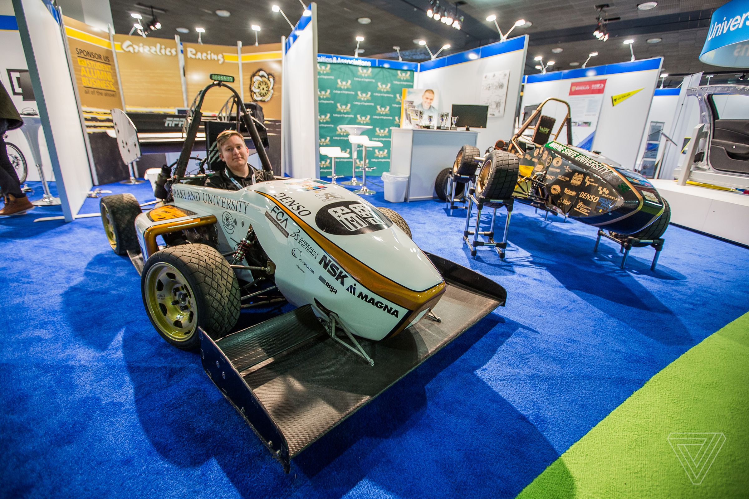 Paul Hollinsky of the Oakland University Formula SAE team sits in his club’s racecar. Automotive projects from a number of different colleges and universities are on display in the Automobili-D section downstairs at the show.