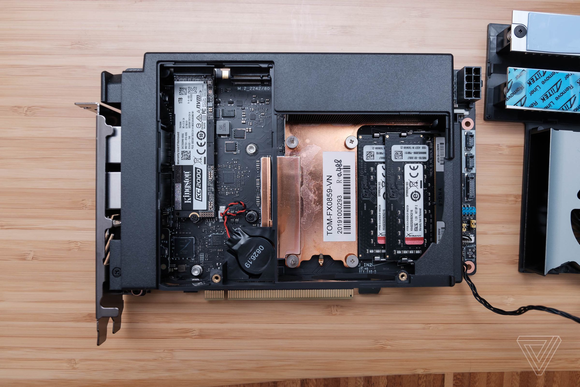 Under a fan is where the CPU, two storage drives, and laptop-size RAM slots are located.