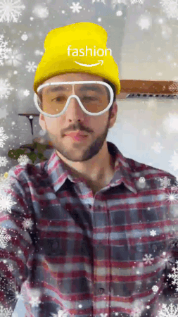 A gif of a man trying out a pair of Ski sunglasses in AR, with a yellow hate and frosty backdrop.