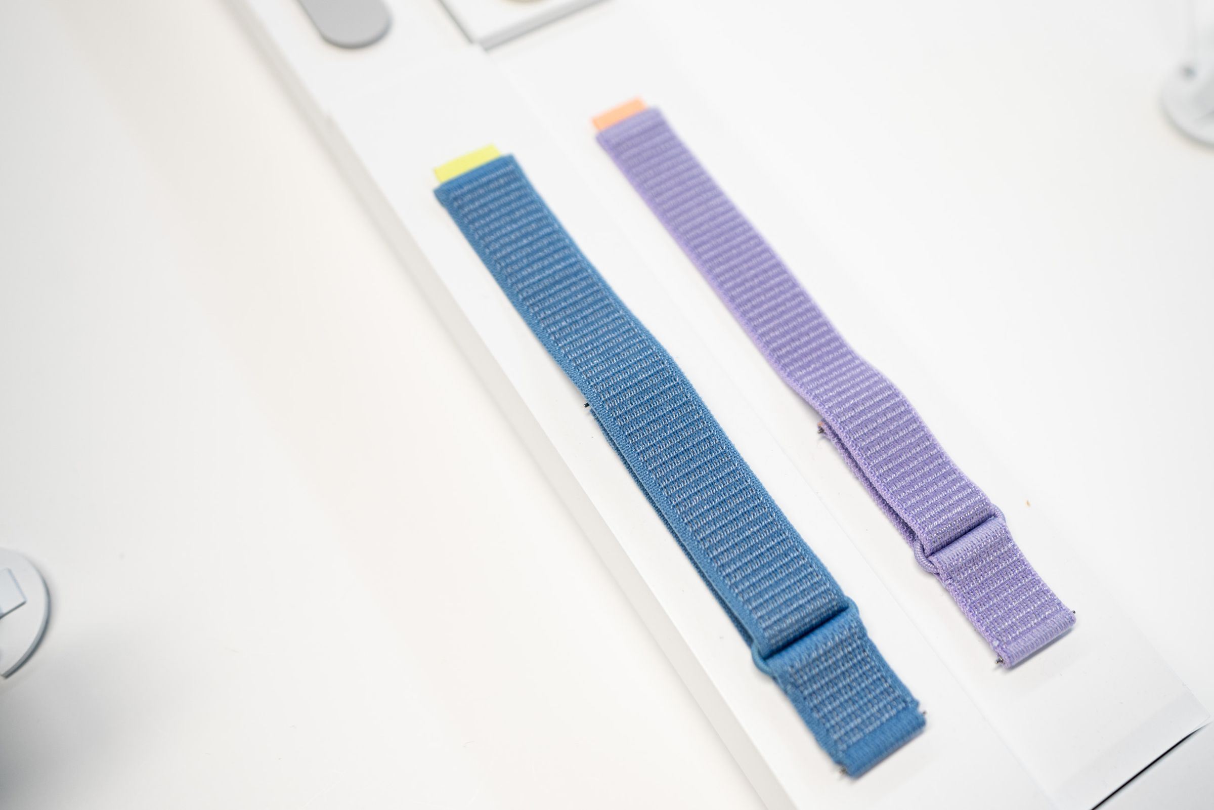 A blue and purple fabric strap side by side