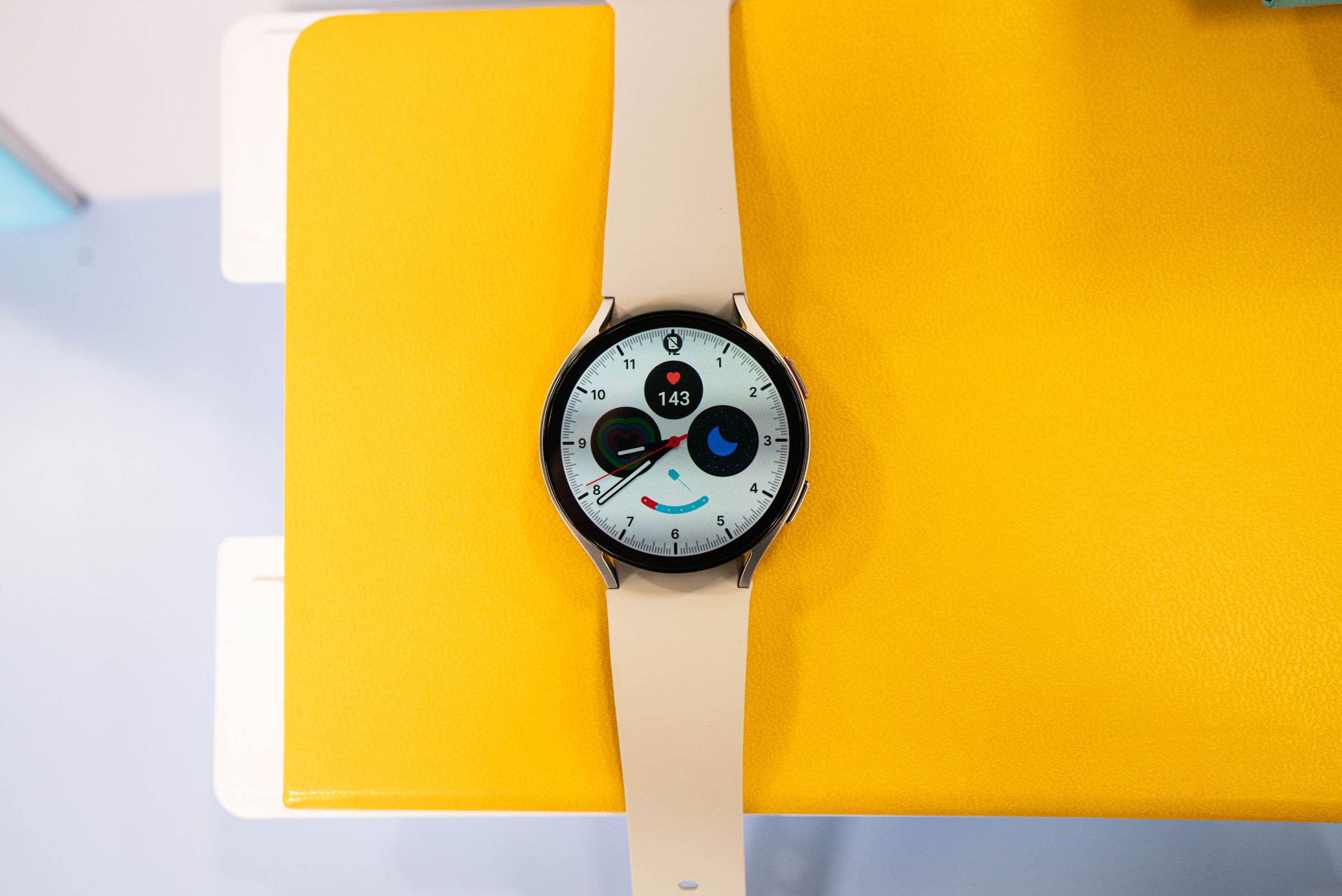The Galaxy Watch 6 in the 44mm size on a yellow surface