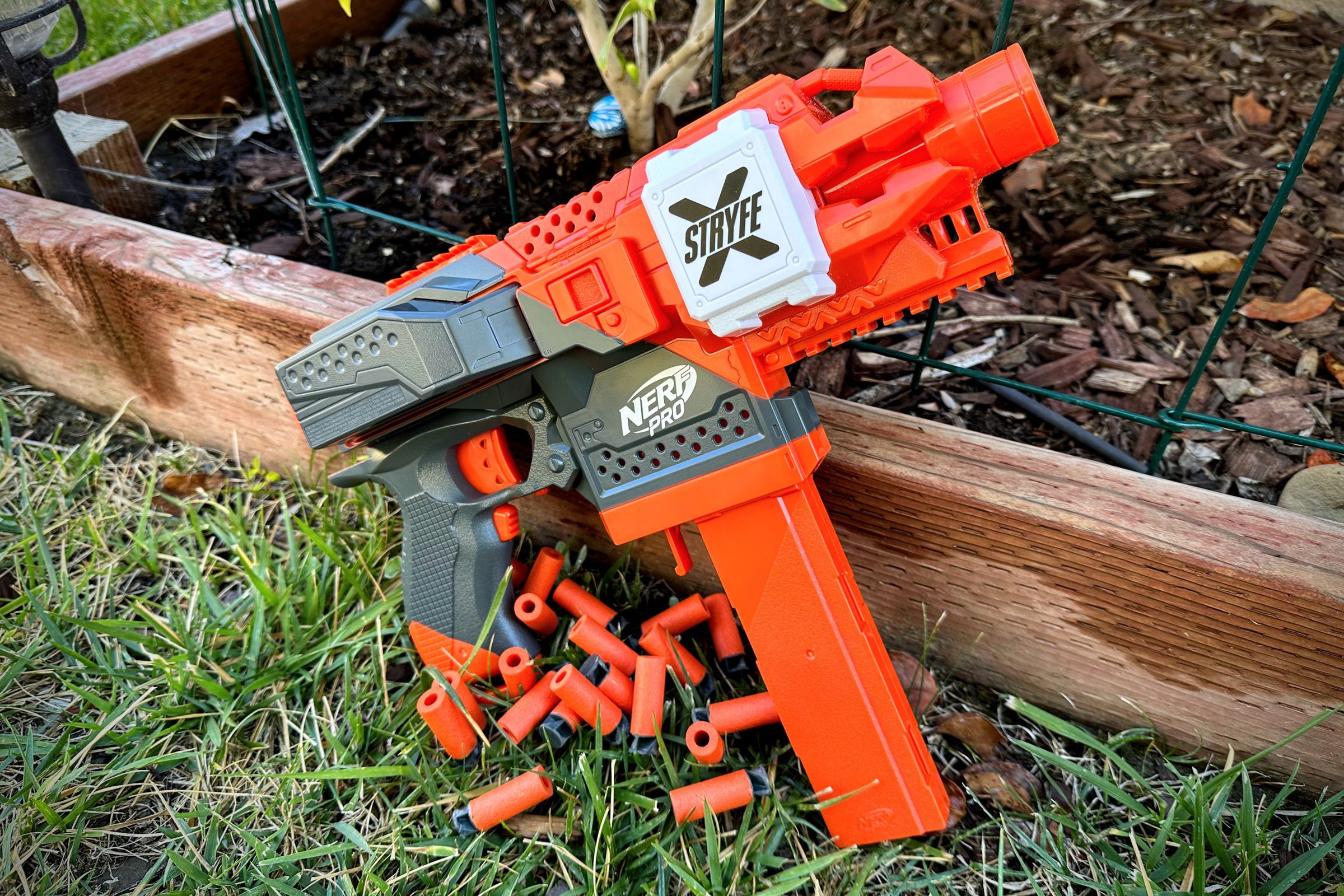 A bright orange SMG-shaped blaster with a long vertical stick magazine.